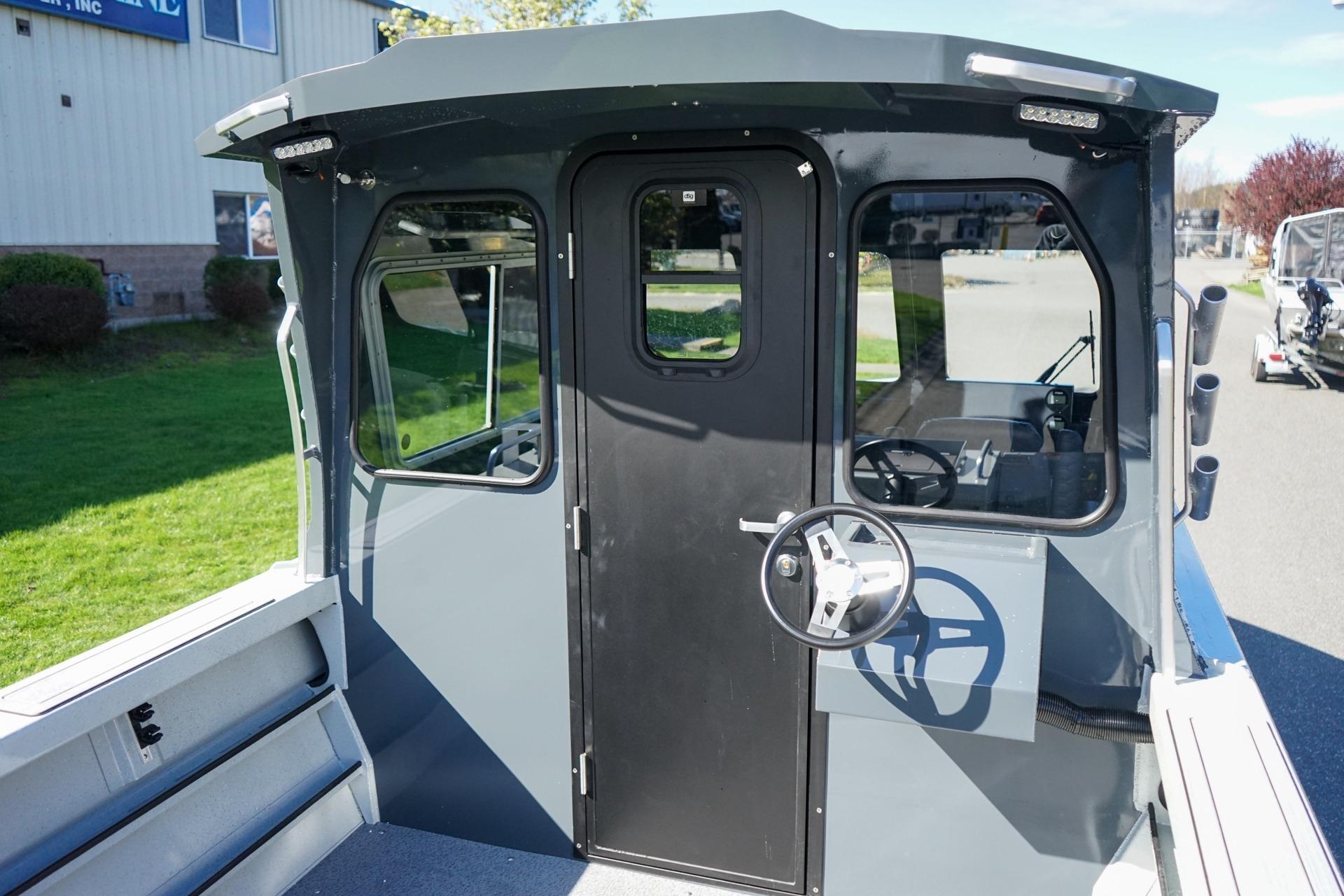 2026 Weldcraft 210 Revolution boat cabin with steering wheel and windows.