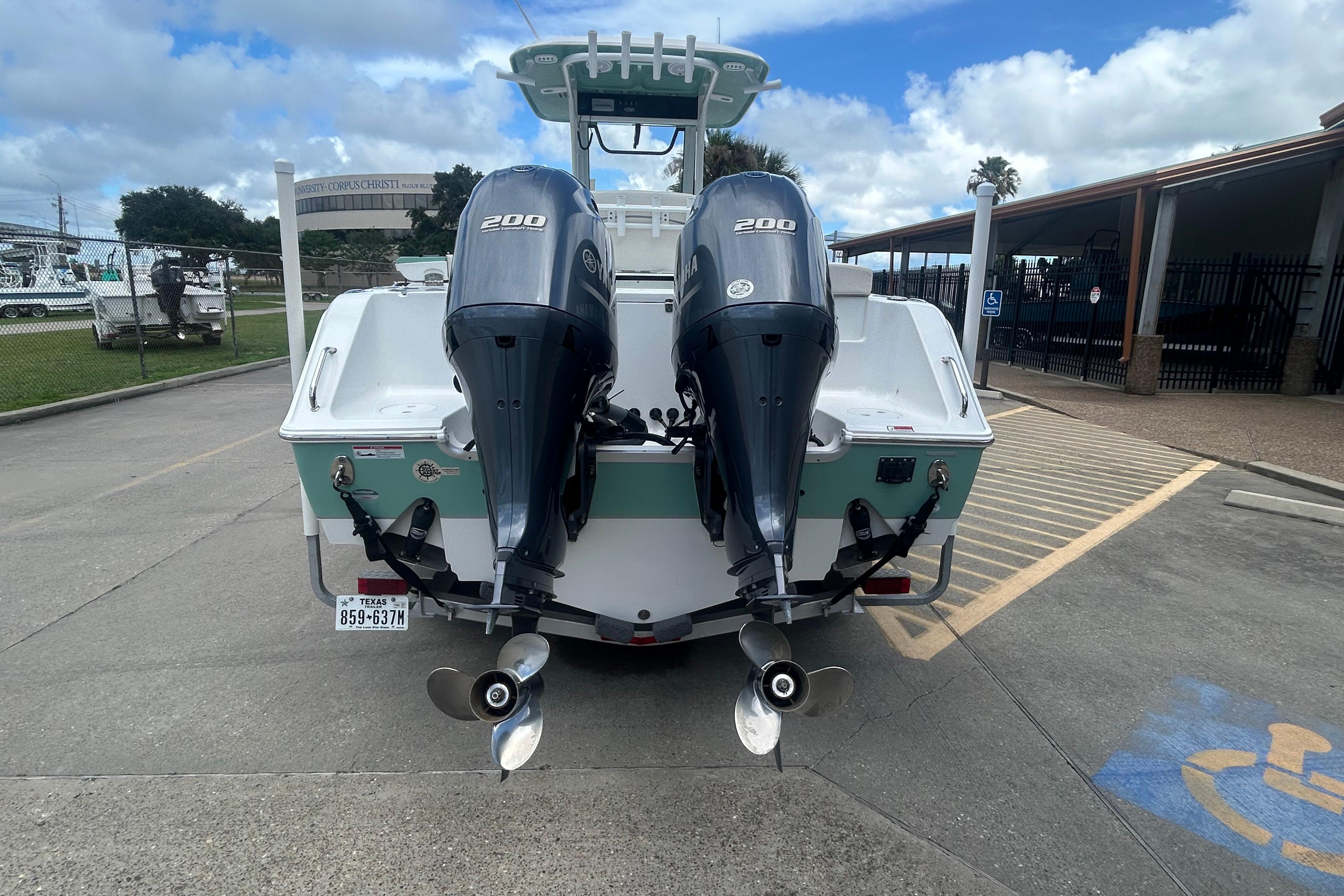 2023 Sea Hunt Gamefish 27 Coffin Box with dual 200 horsepower engines, parked outdoors.