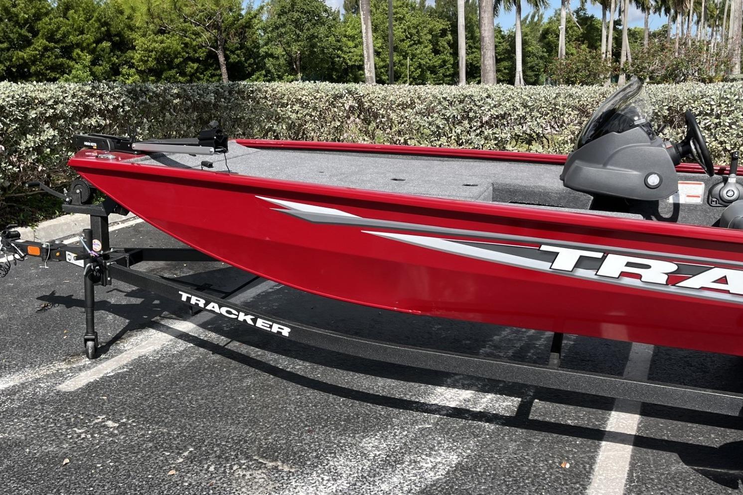 2026 Tracker Pro 170 boat in vibrant red, parked outdoors on a trailer.