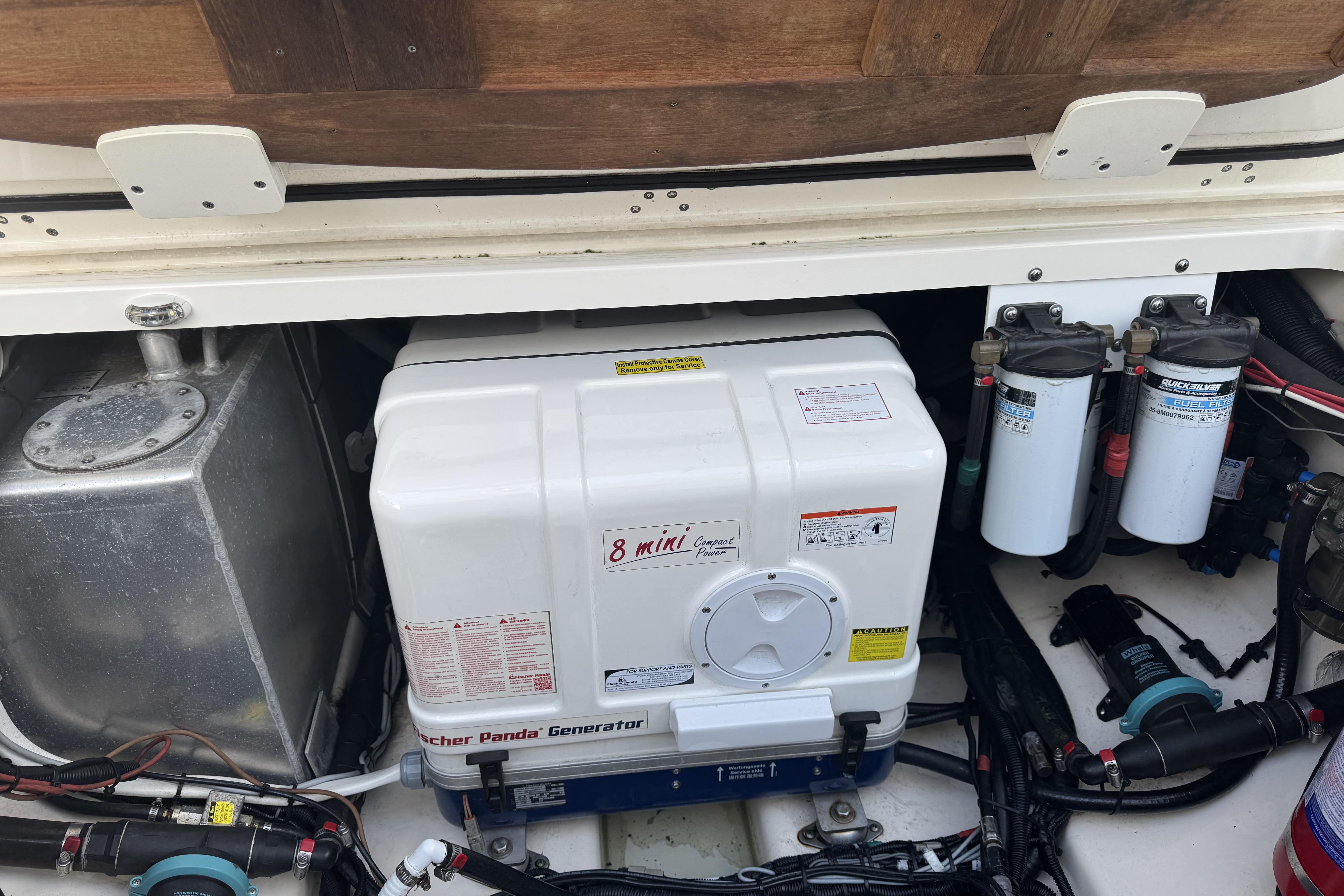 Engine compartment of a 2017 Boston Whaler 370 Outrage with generator and filters.