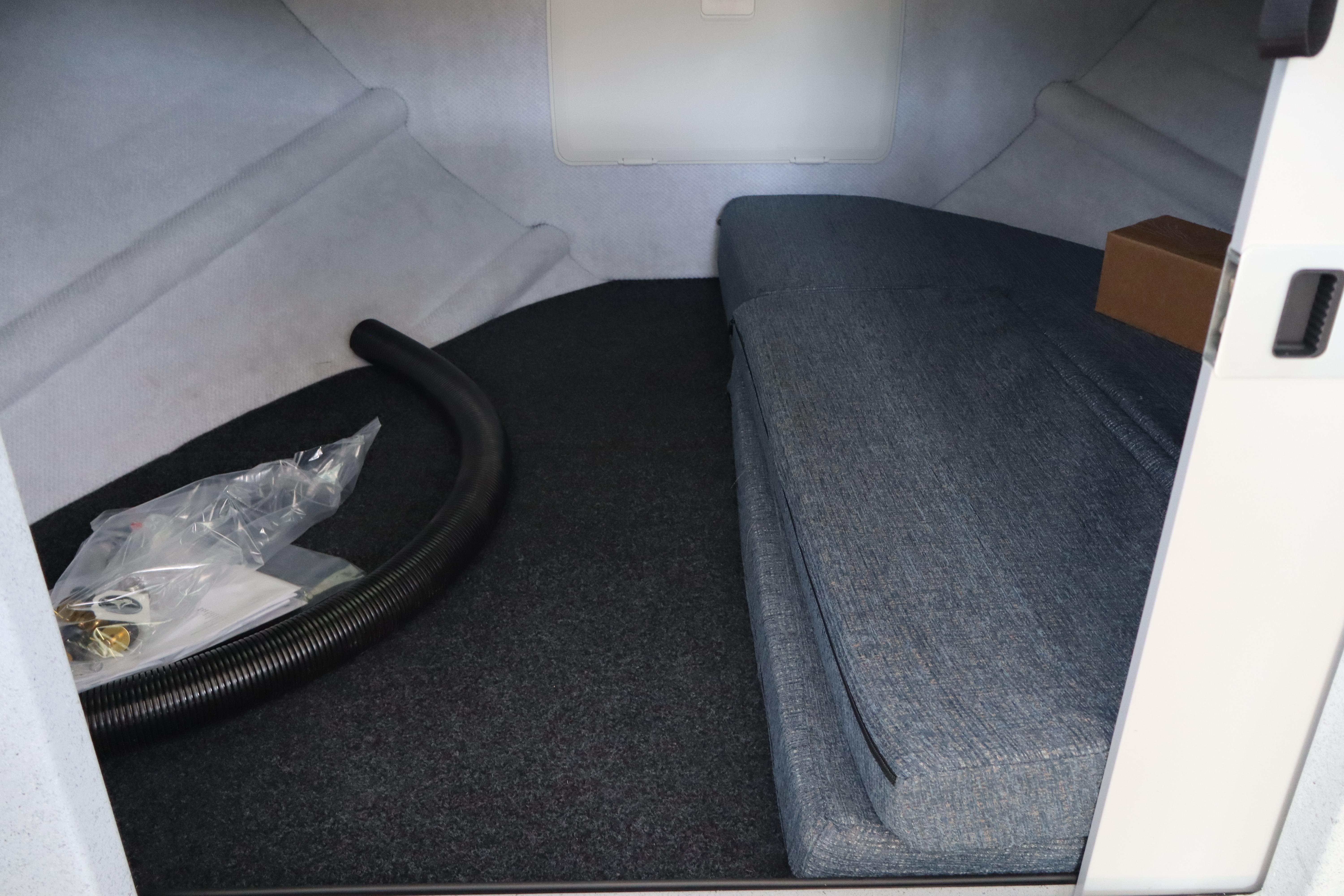 Interior cabin of 2026 KingFisher 25 XAC boat with seating and storage.
