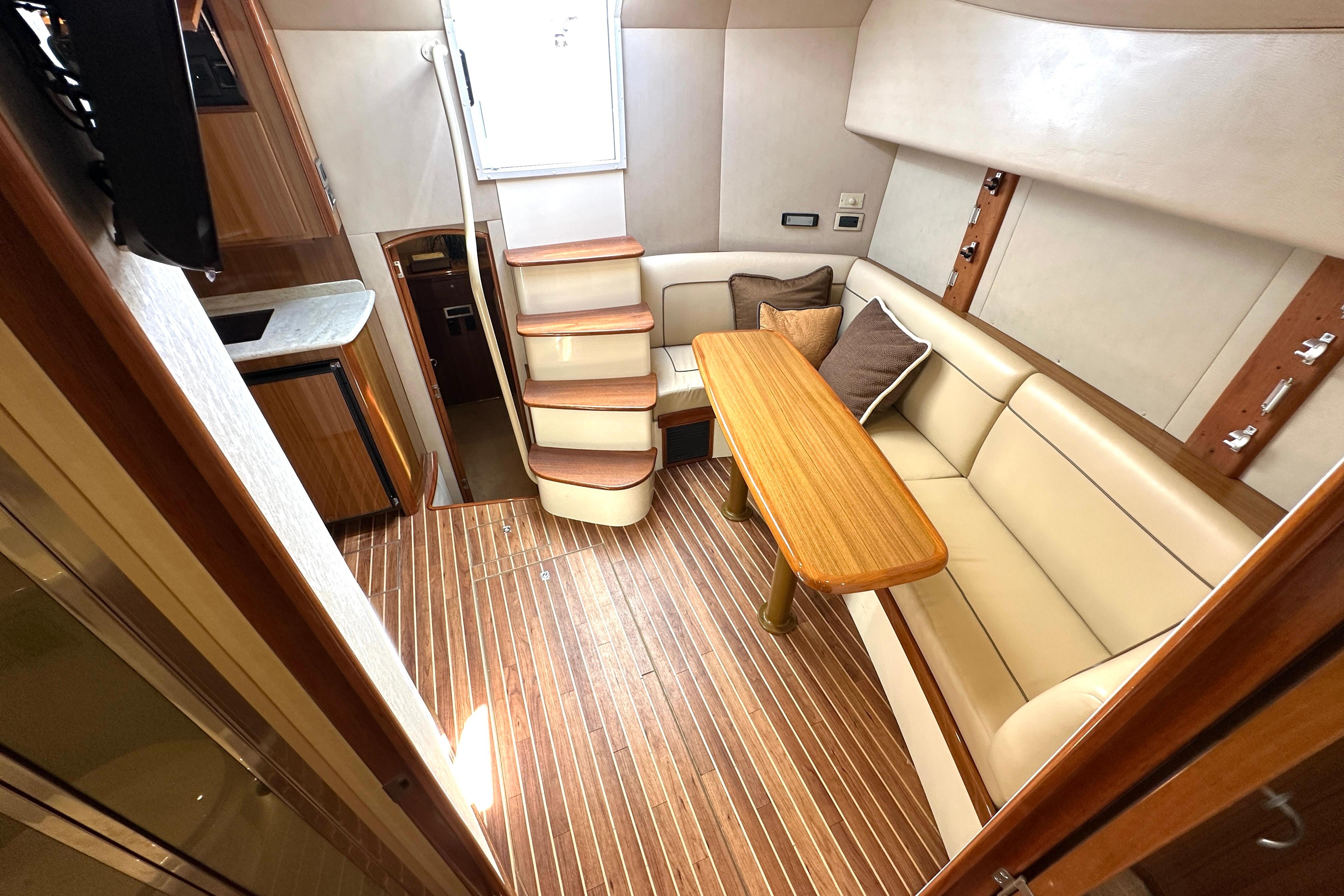 Luxurious interior of 2012 Viking 42 Open yacht with elegant seating and wooden flooring.