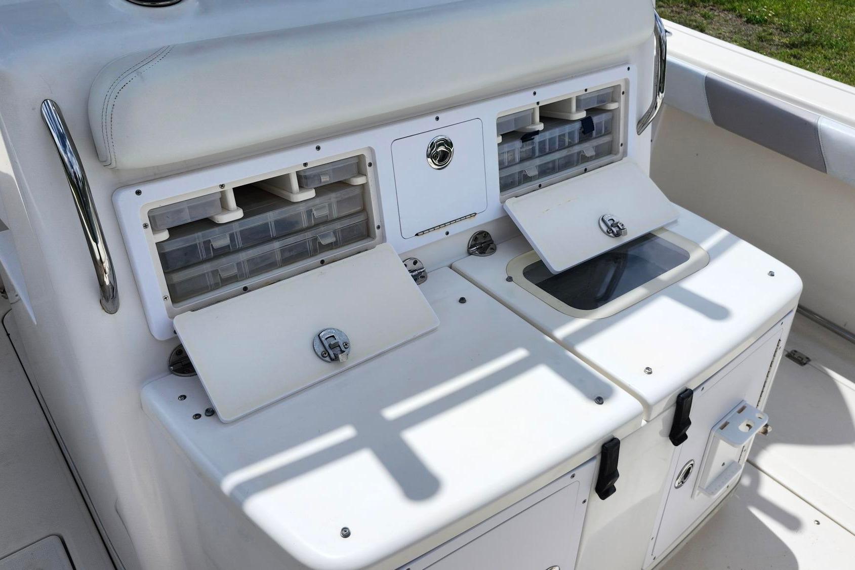 2015 Robalo R300 Center Console fishing tackle storage compartments.