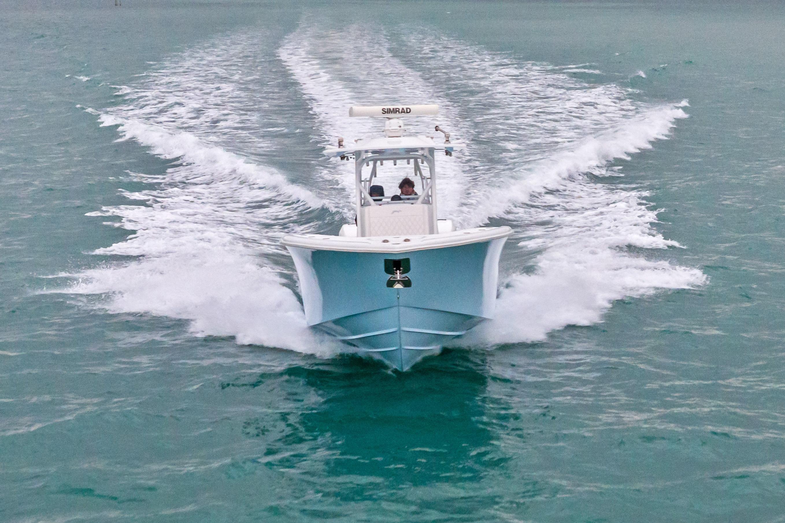 2021 Yellowfin 36 Offshore boat cruising on open water, creating a dynamic wake.