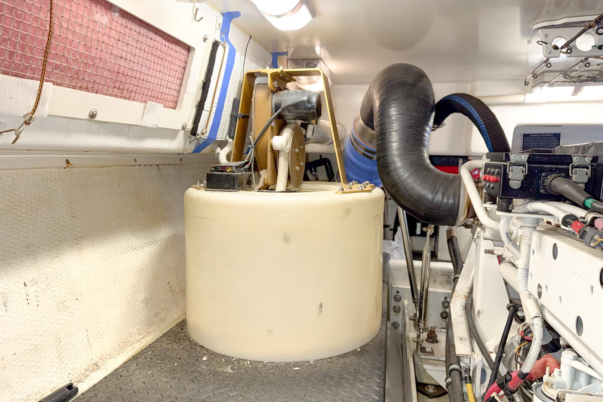 Engine room of a 2004 Silverton 48 Convertible yacht, featuring mechanical components.