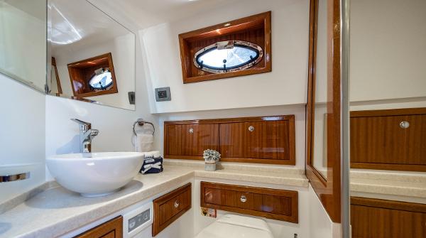 Elegant bathroom in 2023 Vento V40 Retro Classic Open yacht with wooden cabinets and modern fixtures.