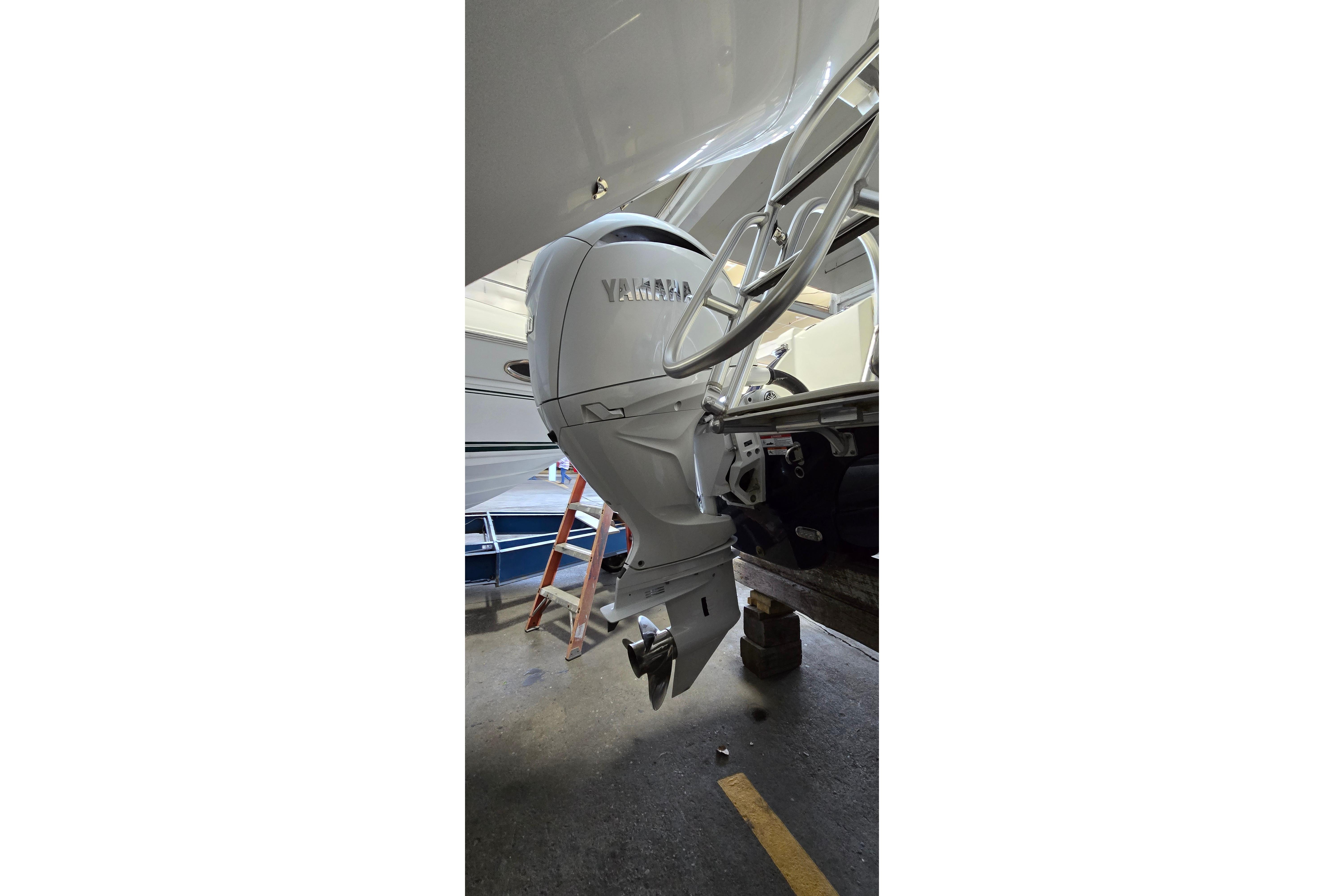 2024 WorldCat 280 CC-X boat with Yamaha outboard motor in a garage setting.