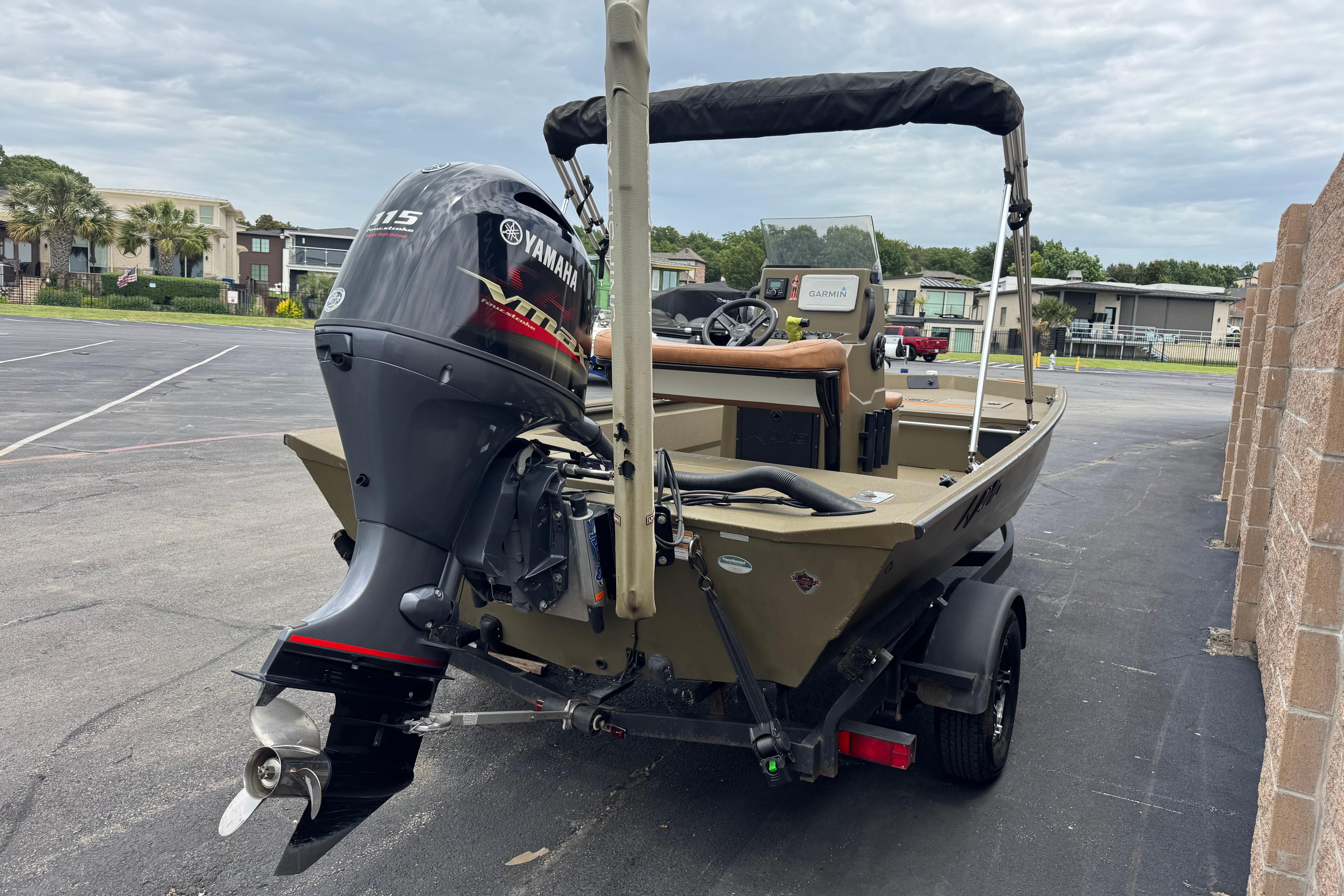 2023 Avid 18 Rogue CC boat with Yamaha 115 engine in parking lot.