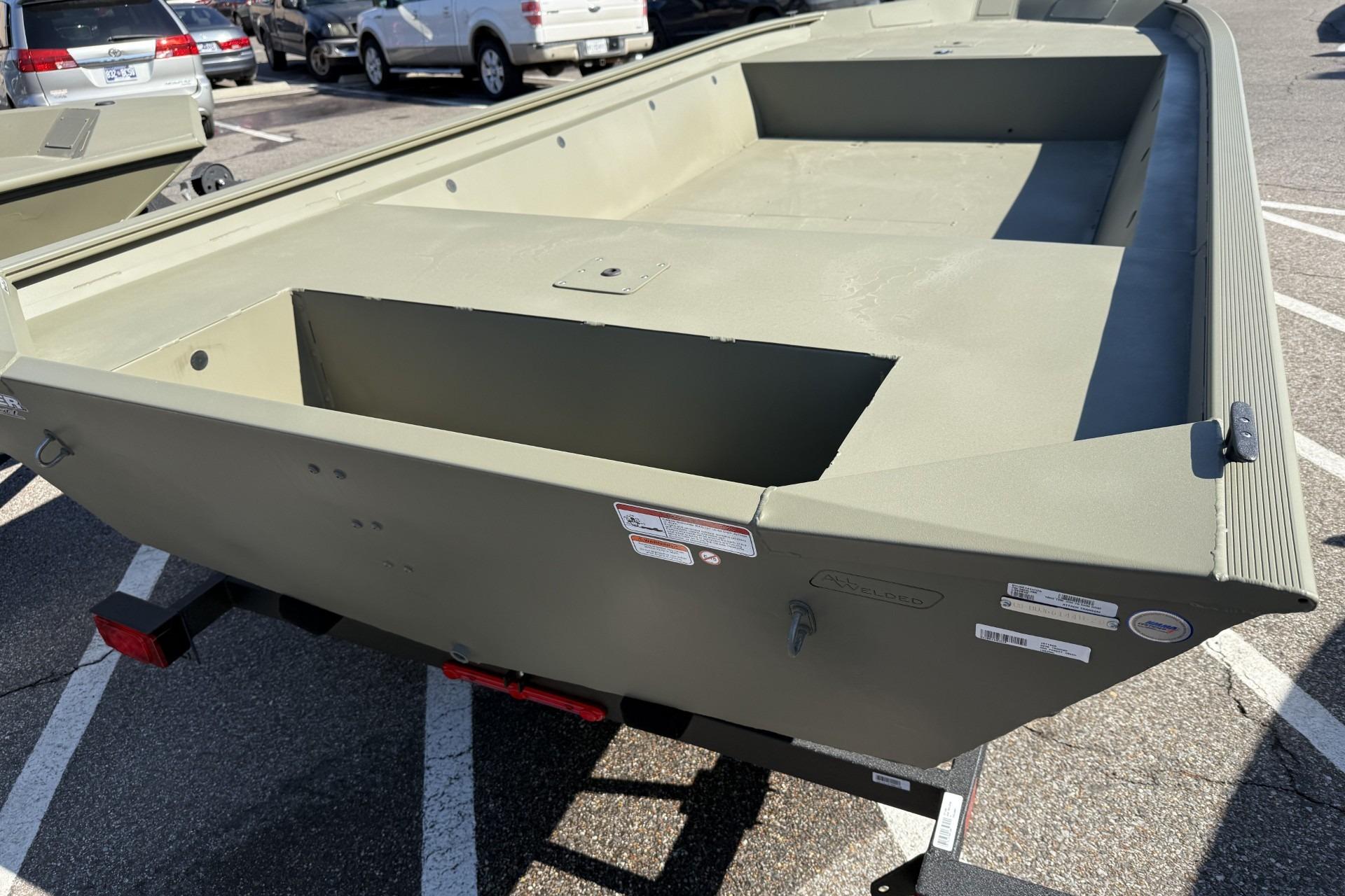 2026 Tracker Grizzly 1860 Utility boat on trailer in parking lot.