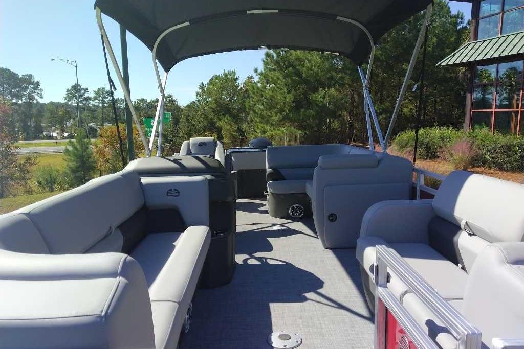 2026 Sun Tracker SportFish 22 DLX pontoon boat with spacious seating and canopy.