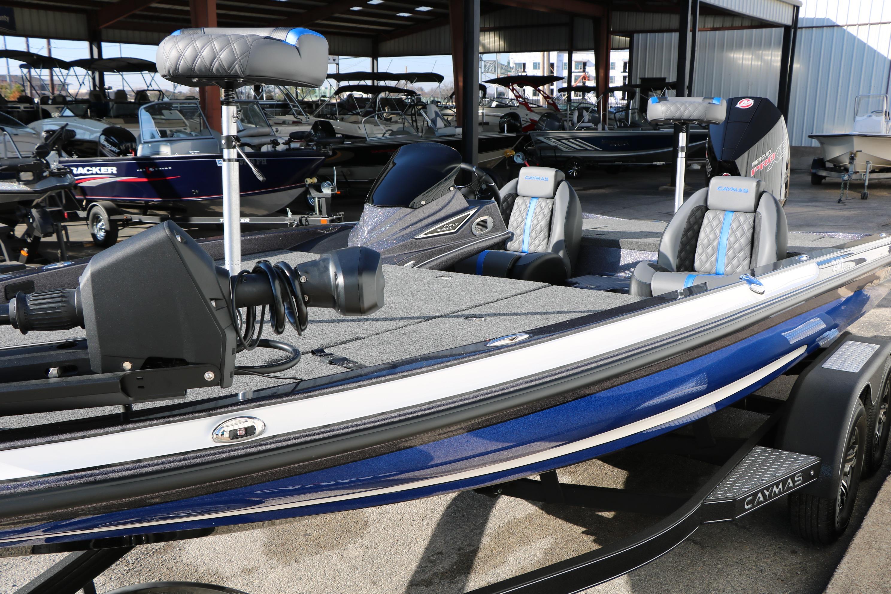 2027 Caymas 201 Pro fishing boat with blue accents in a showroom.