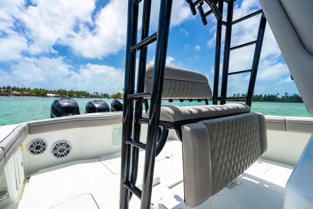 2015 Yellowfin CC boat interior with seating, ocean view, and clear blue sky.