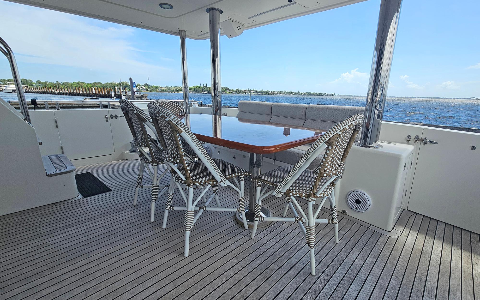 Outdoor dining area on 2012 Outer Reef Yachts 700 Motoryacht with ocean view.
