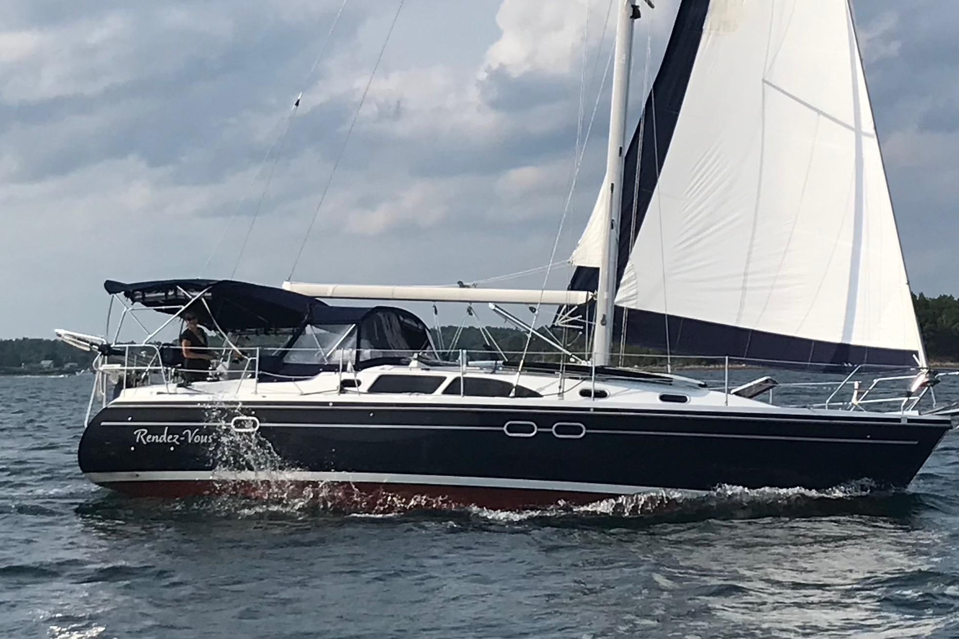Sailing yacht Catalina 387, 2003 model, cruising on open water under cloudy skies.