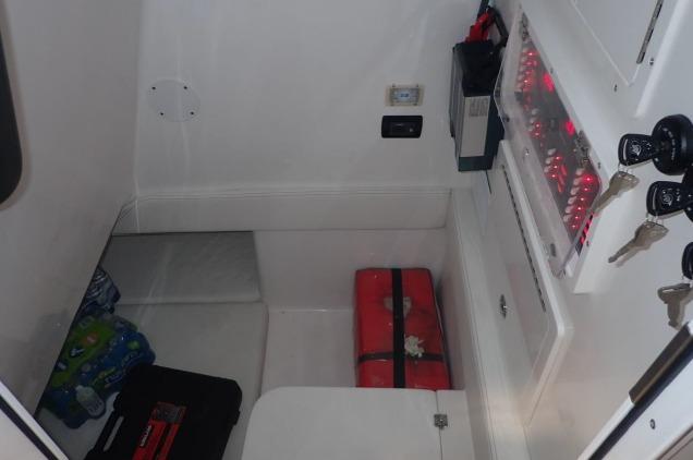 Interior cabin of 2022 SeaHunter 35 Tournament boat with storage and electrical panel.
