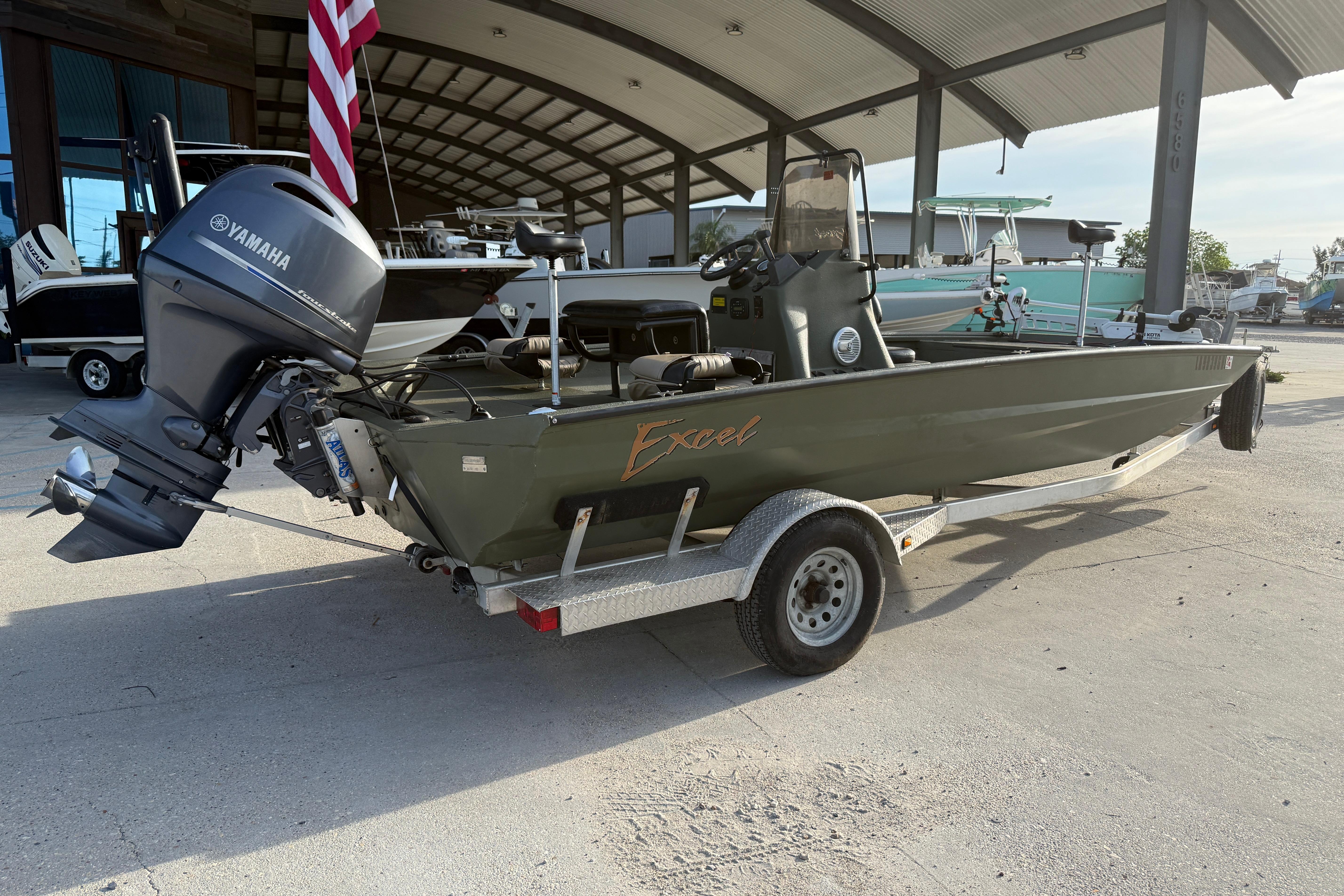 2014 Excel 203 Bay Pro boat with Yamaha outboard motor on trailer, parked under a canopy.