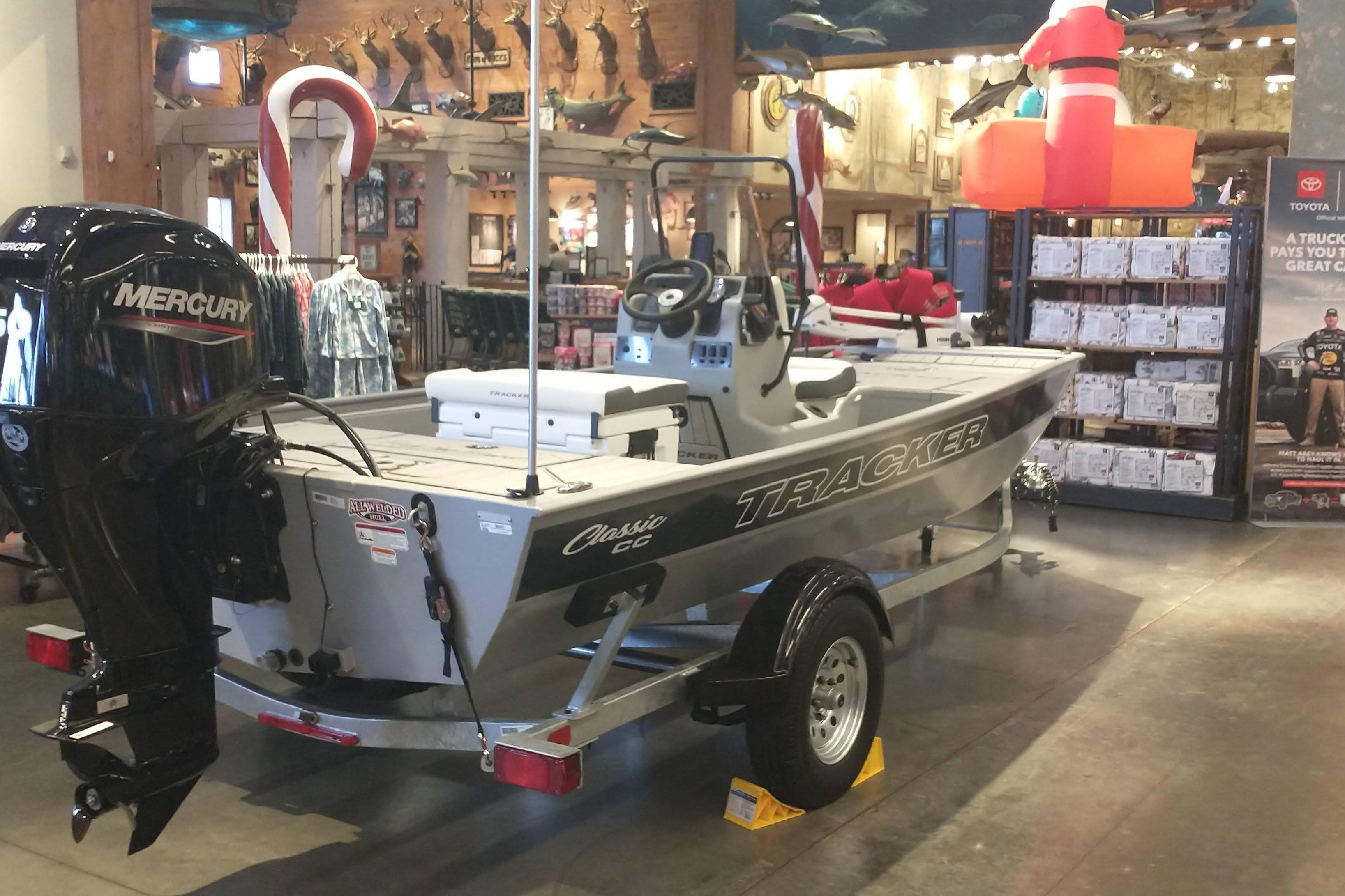 2026 Tracker Bass Tracker Classic CC boat displayed indoors with Mercury engine.