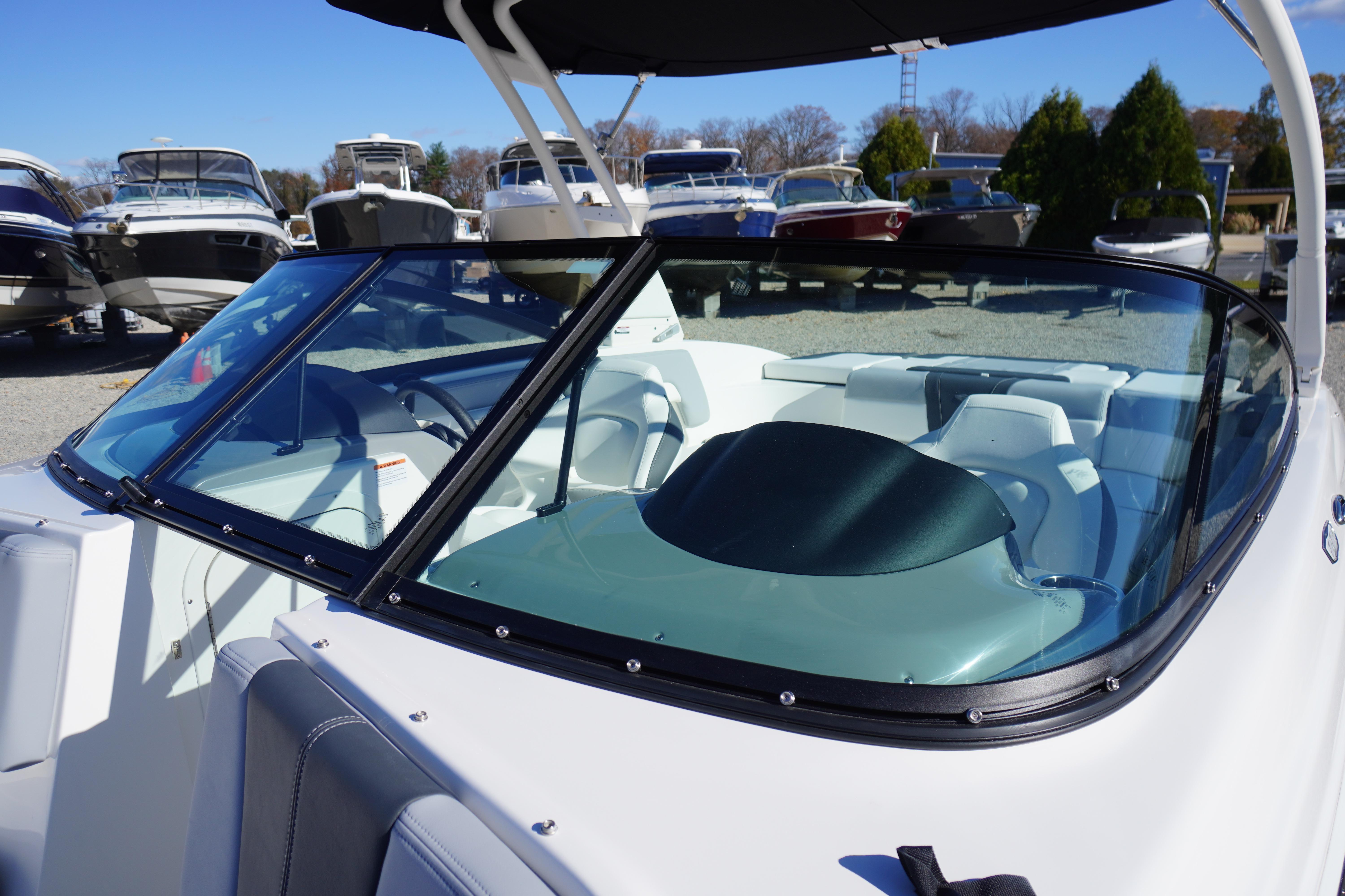 2026 Chaparral 23 SSi boat with sleek windshield and modern interior design.