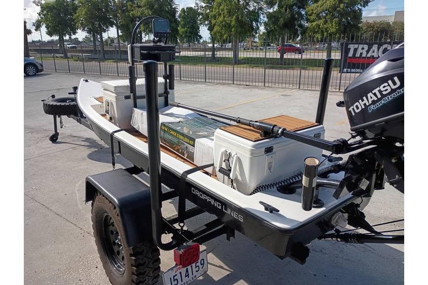 2013 Pelican Ambush boat with Tohatsu motor on a trailer, equipped for fishing.