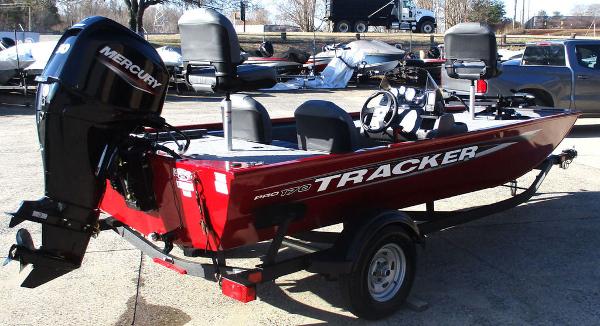 2025 Tracker Pro 170 boat with Mercury engine, red exterior, parked on trailer.
