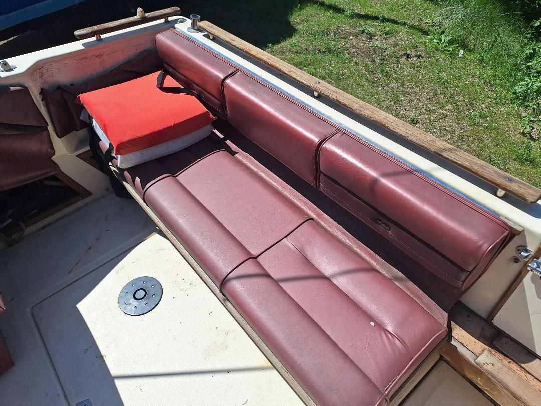 Interior of a 1986 Sea Ray Weekender 230 with red upholstery.