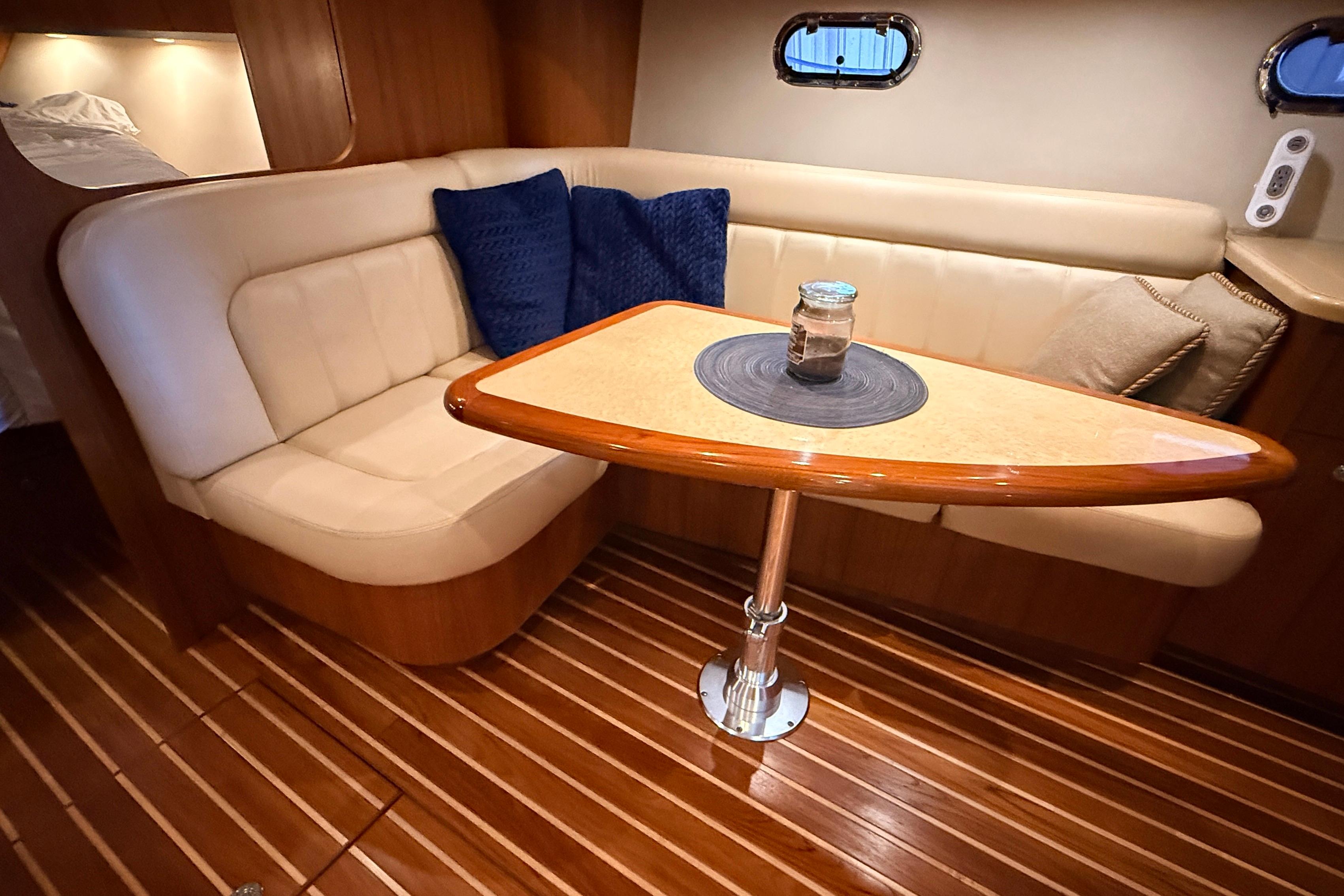 Luxurious interior of 2004 Tiara Yachts 3600 Sovran with elegant seating and wooden table.