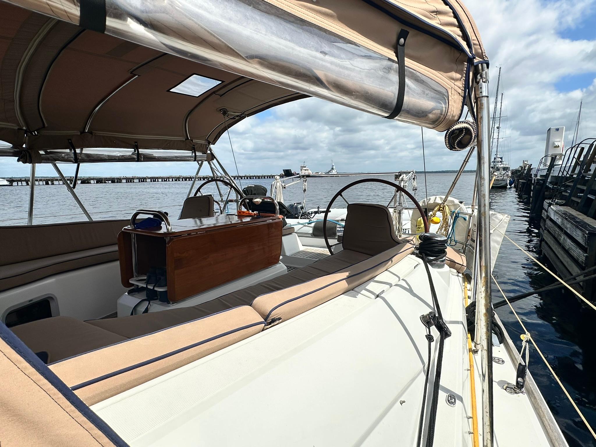 2011 Jeanneau Sun Odyssey 45 DS sailboat docked, featuring spacious deck and helm.