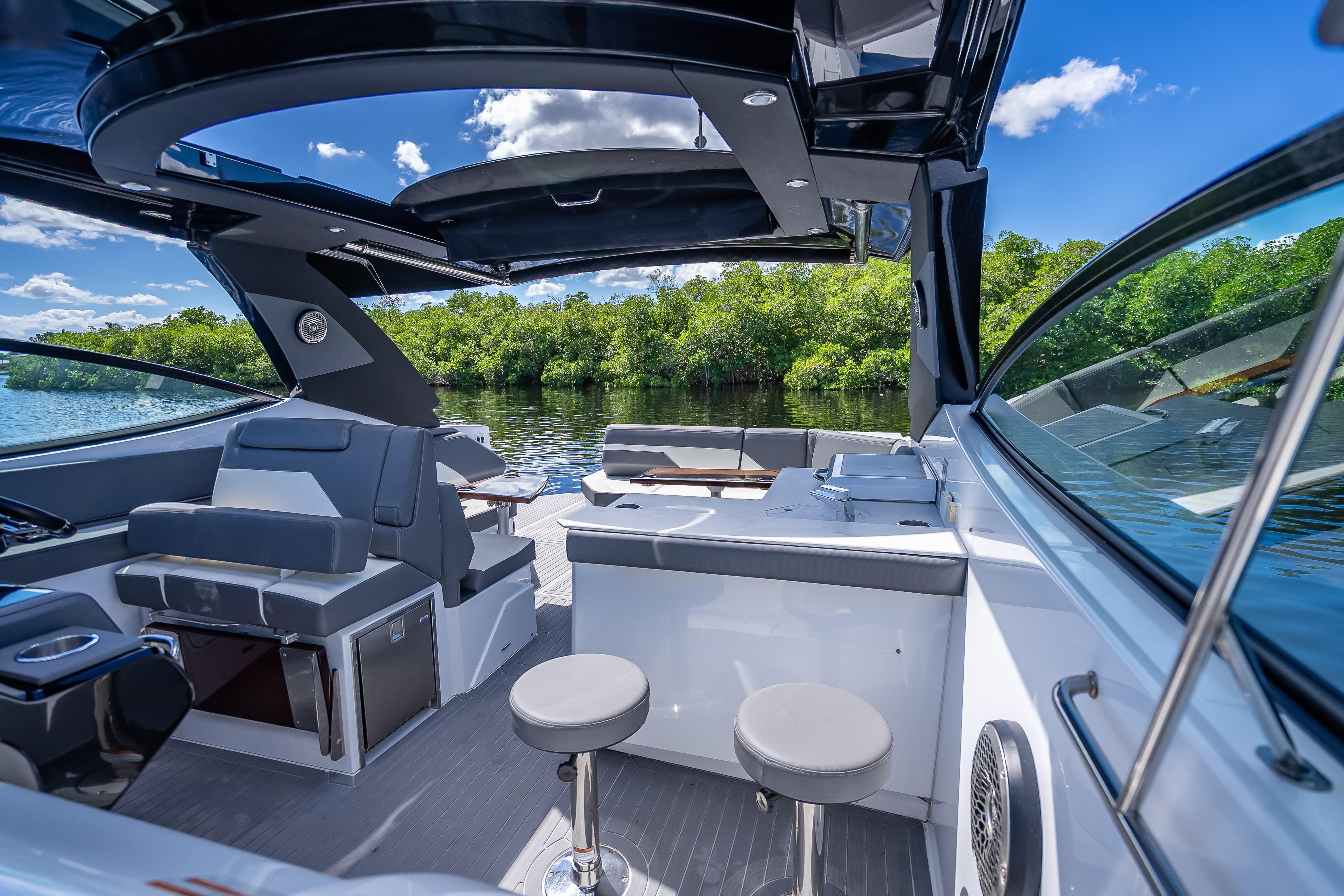 Luxurious 2022 Cruisers Yachts 38 GLS OB interior with sleek seating and open canopy.