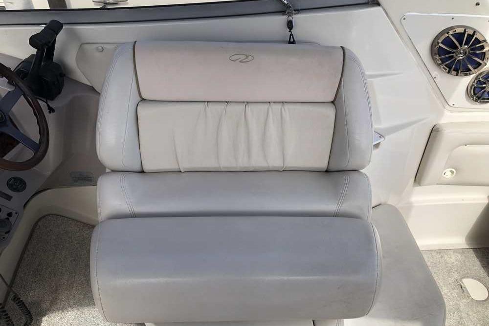 1999 Regal Commodore 2760 boat interior with plush seating and steering wheel.