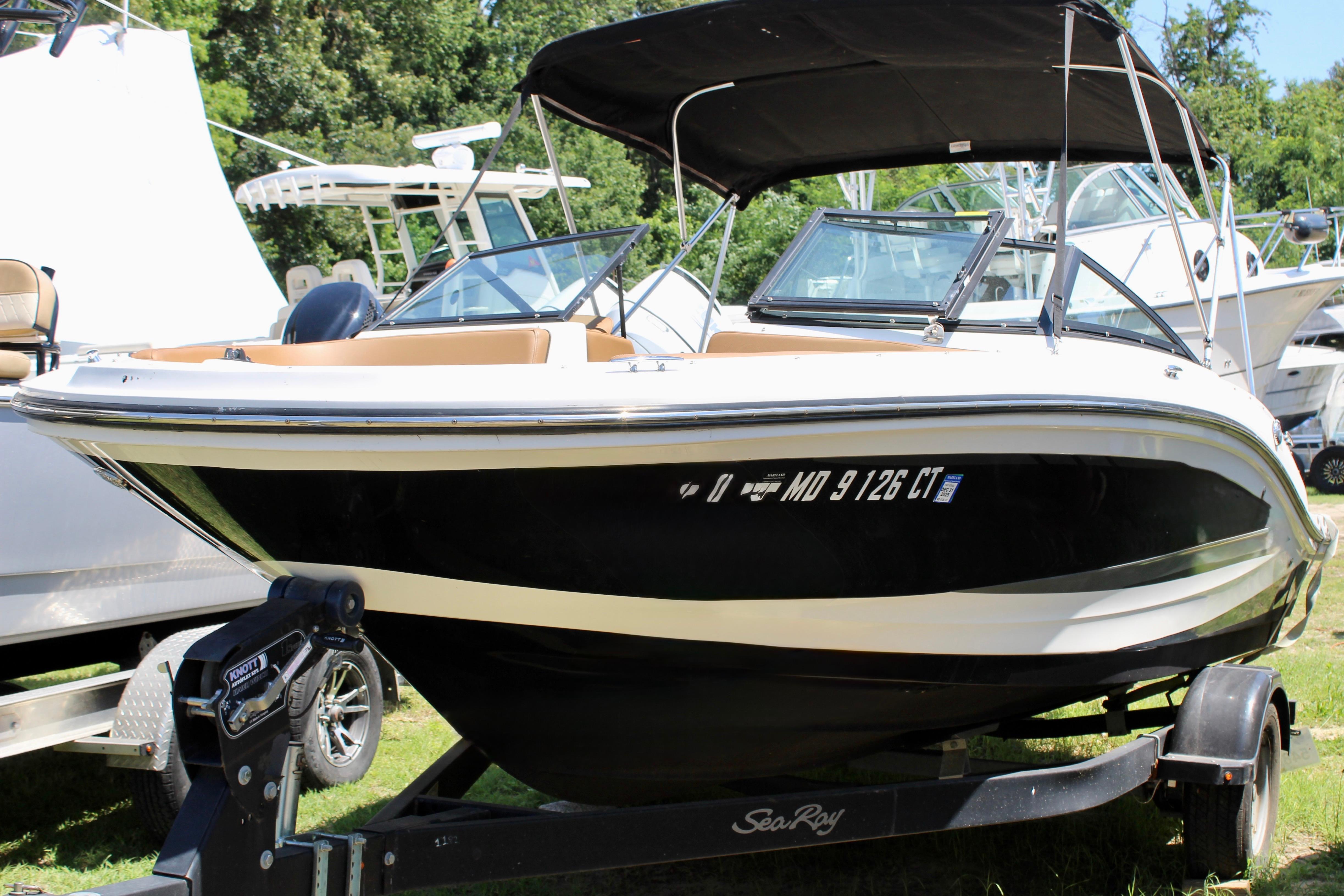 2018 Sea Ray SPX 190 Outboard boat on trailer, parked outdoors.
