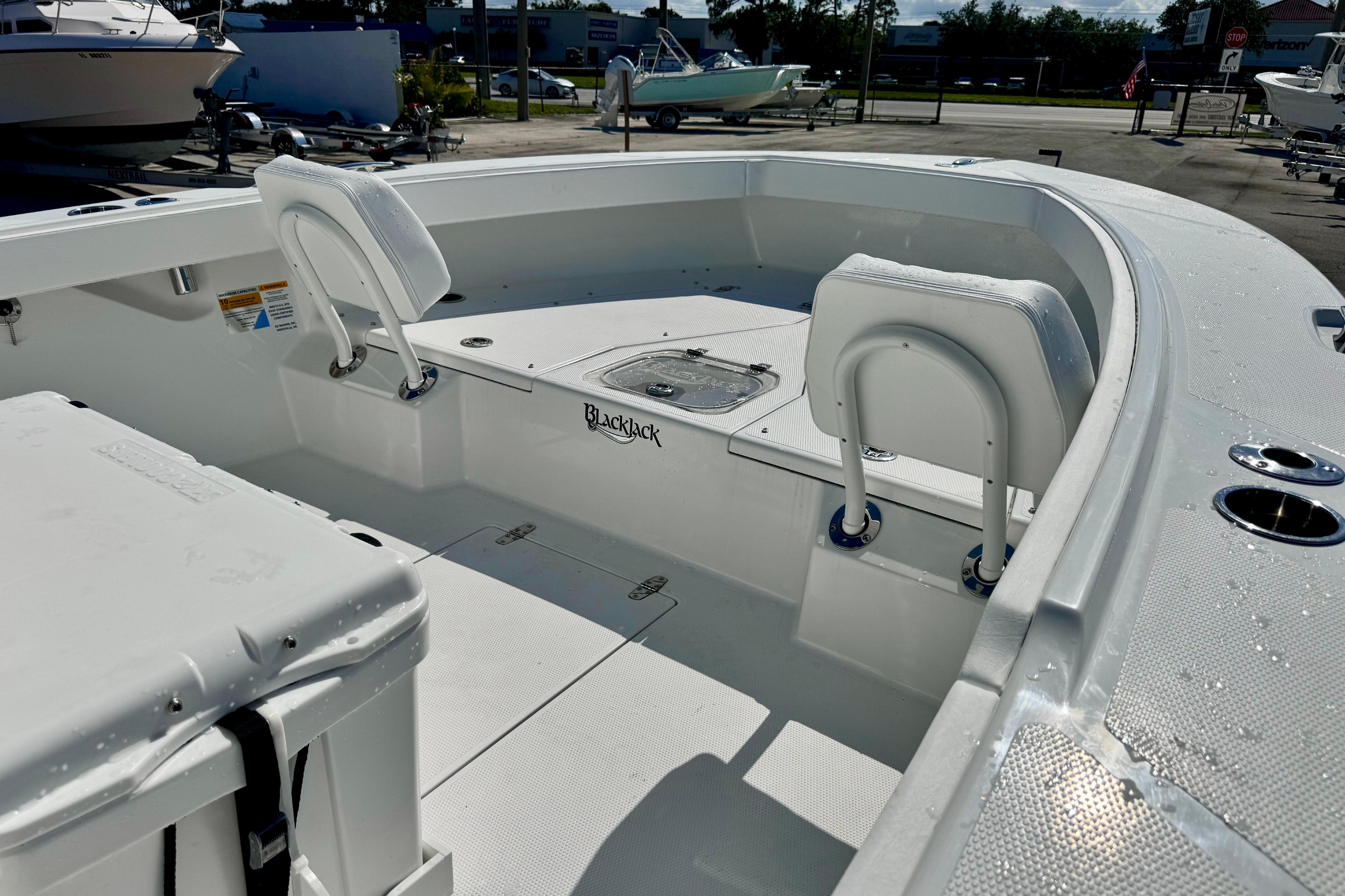 2026 BlackJack 256 Coastal boat interior with seating and storage compartments.
