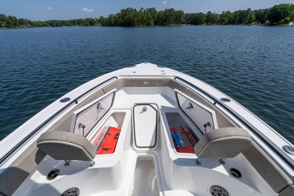 Manufacturer Provided Image: 2026 Sea Hunt Ultra 255 SE boat with open storage compartments on a serene lake.