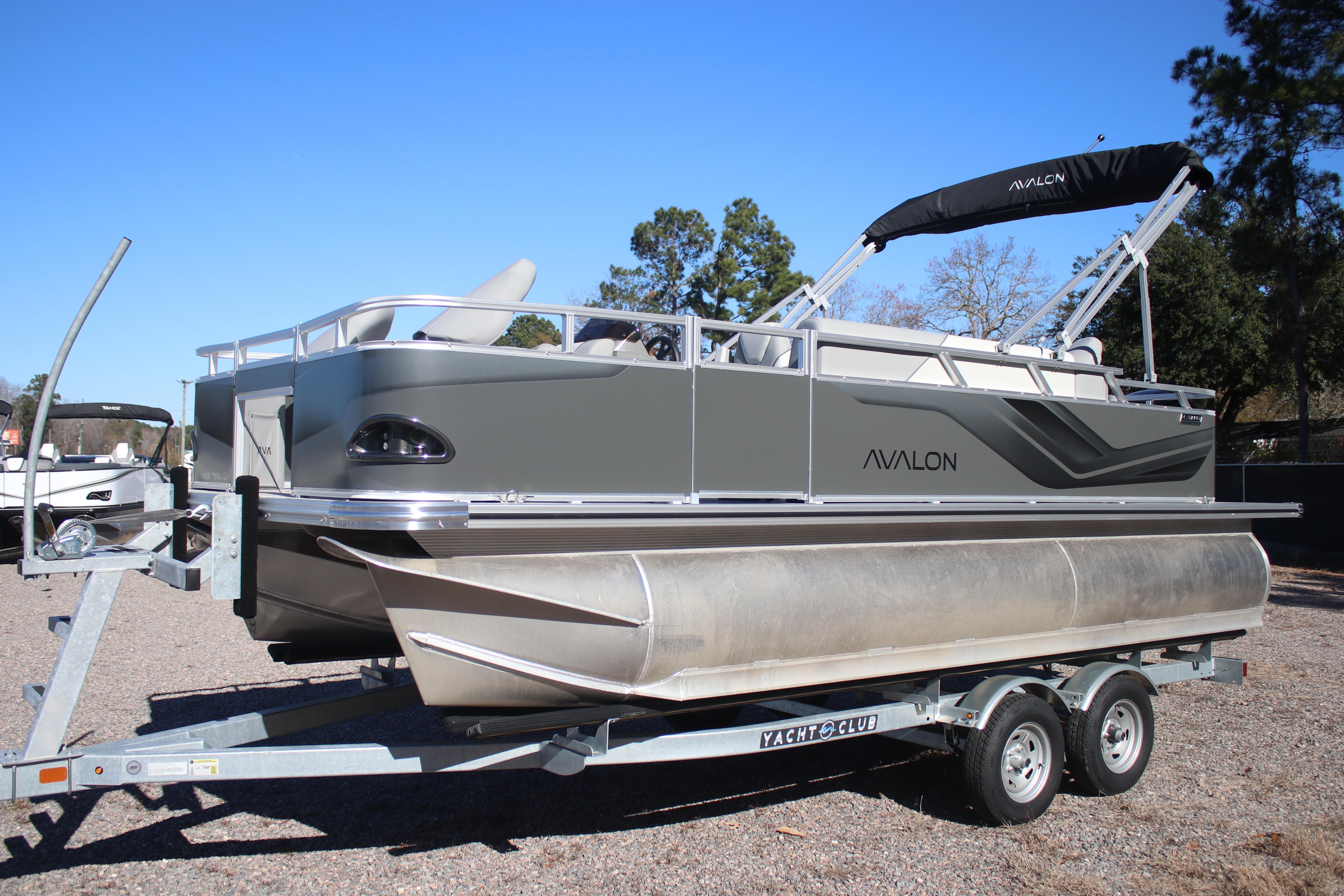 2026 Avalon VENTURE 85 QUAD pontoon boat on trailer, parked outdoors.
