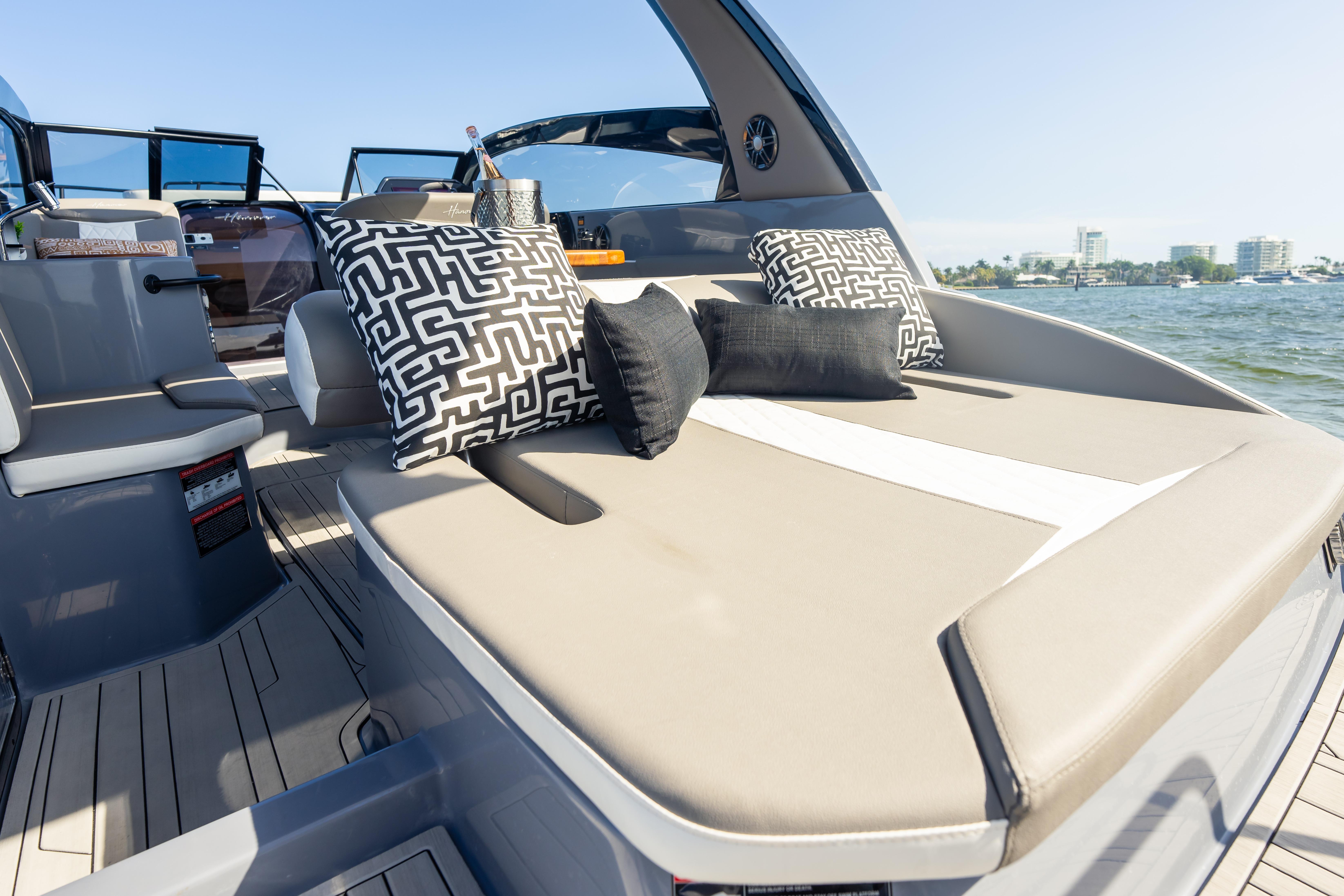 Luxurious 2026 Hanover 305 boat interior with stylish cushions and scenic water view.