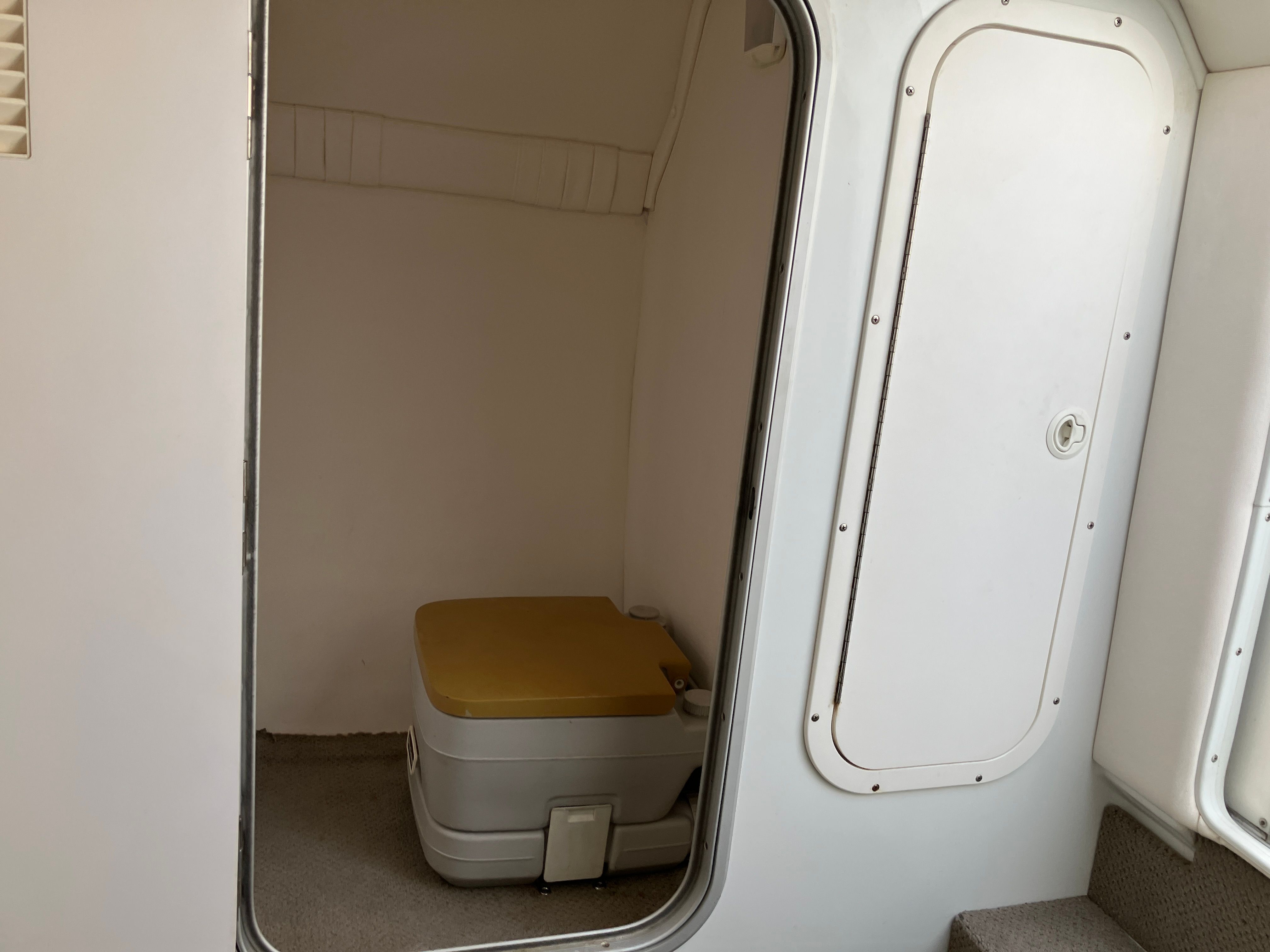 Interior of a 2000 Baja 36 Outlaw with portable toilet.