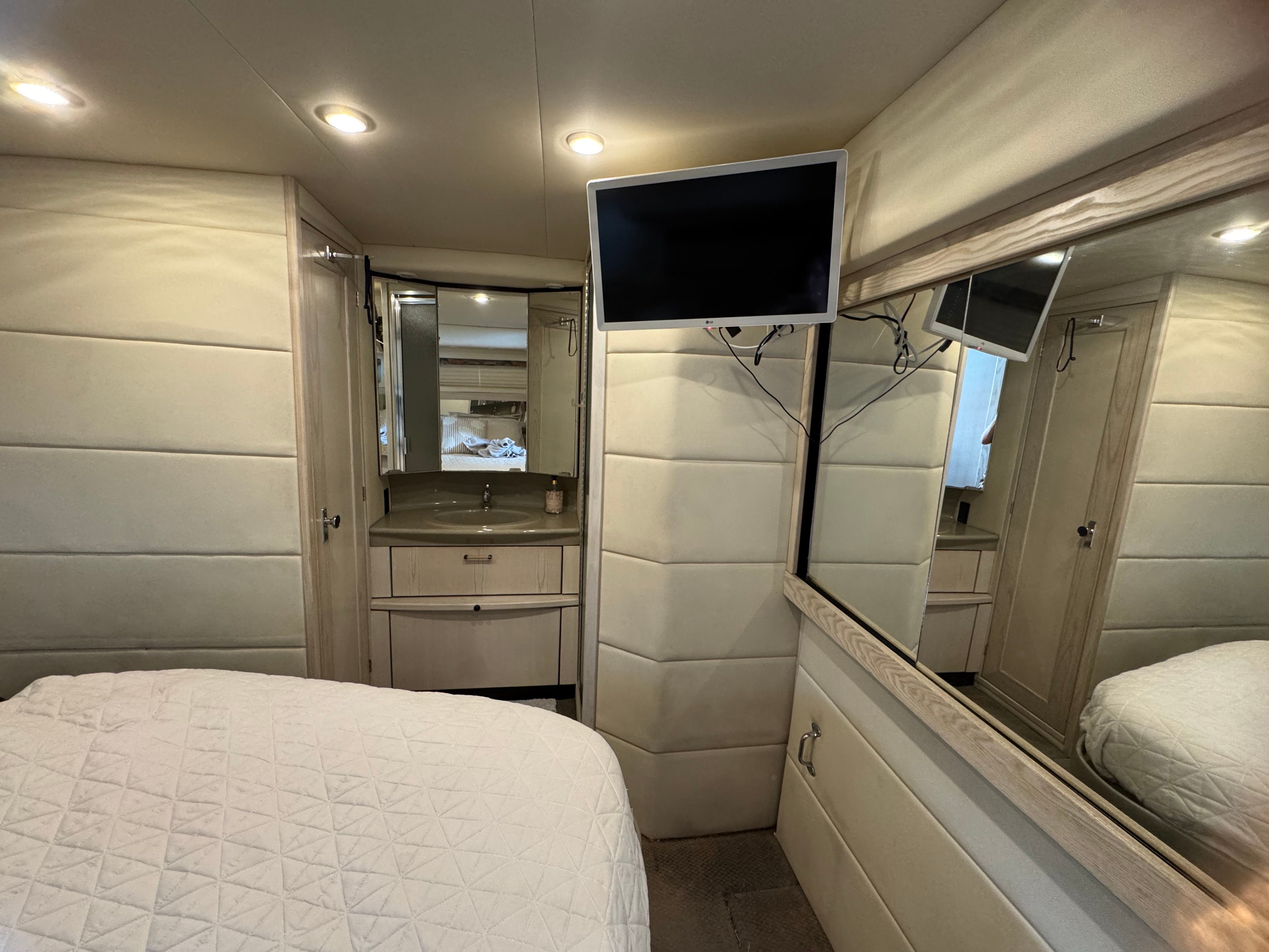 Interior of 1996 Bayliner 3587 yacht with bed and TV.