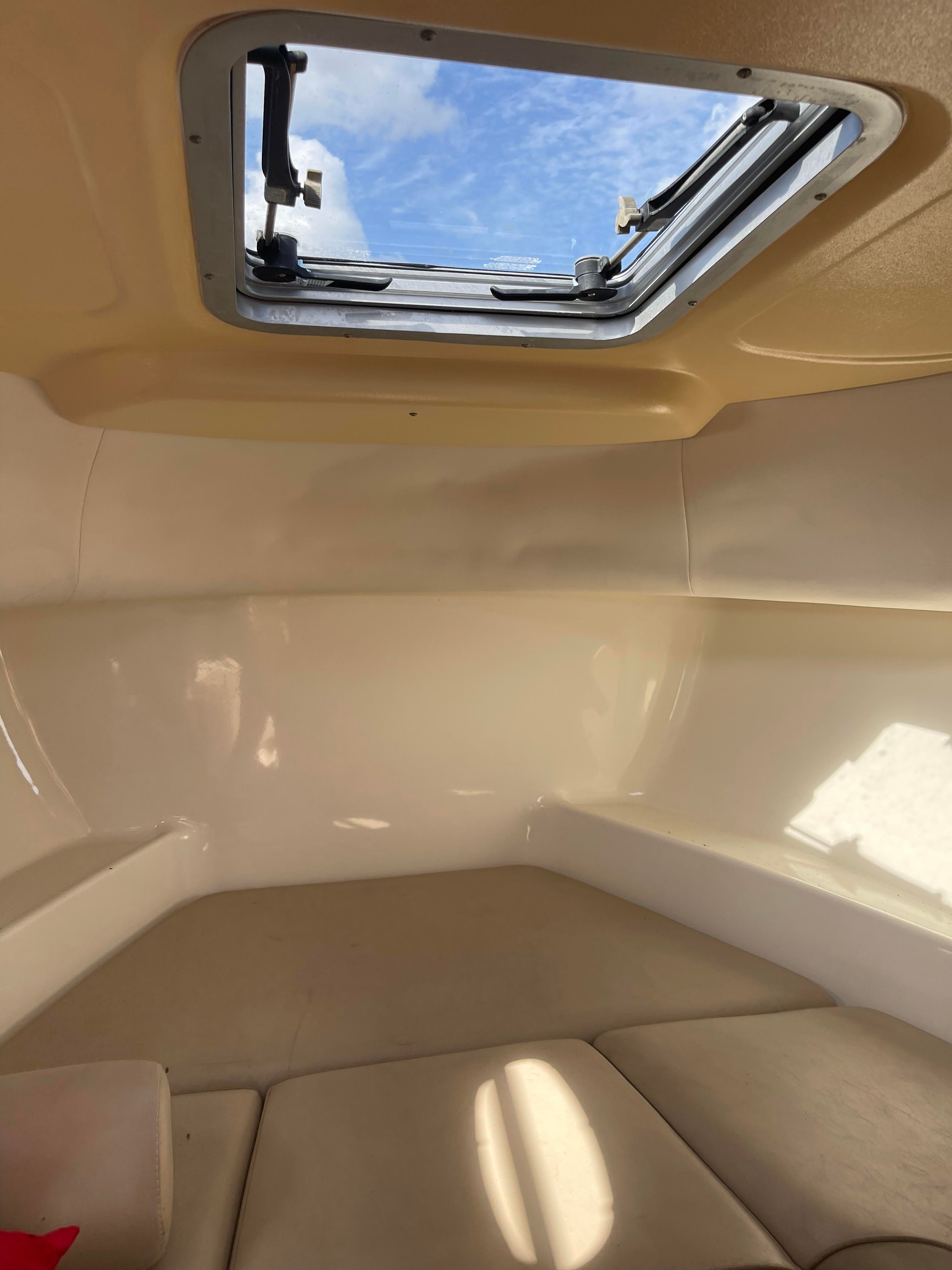 Interior of 2010 Boston Whaler 235 Conquest with skylight.