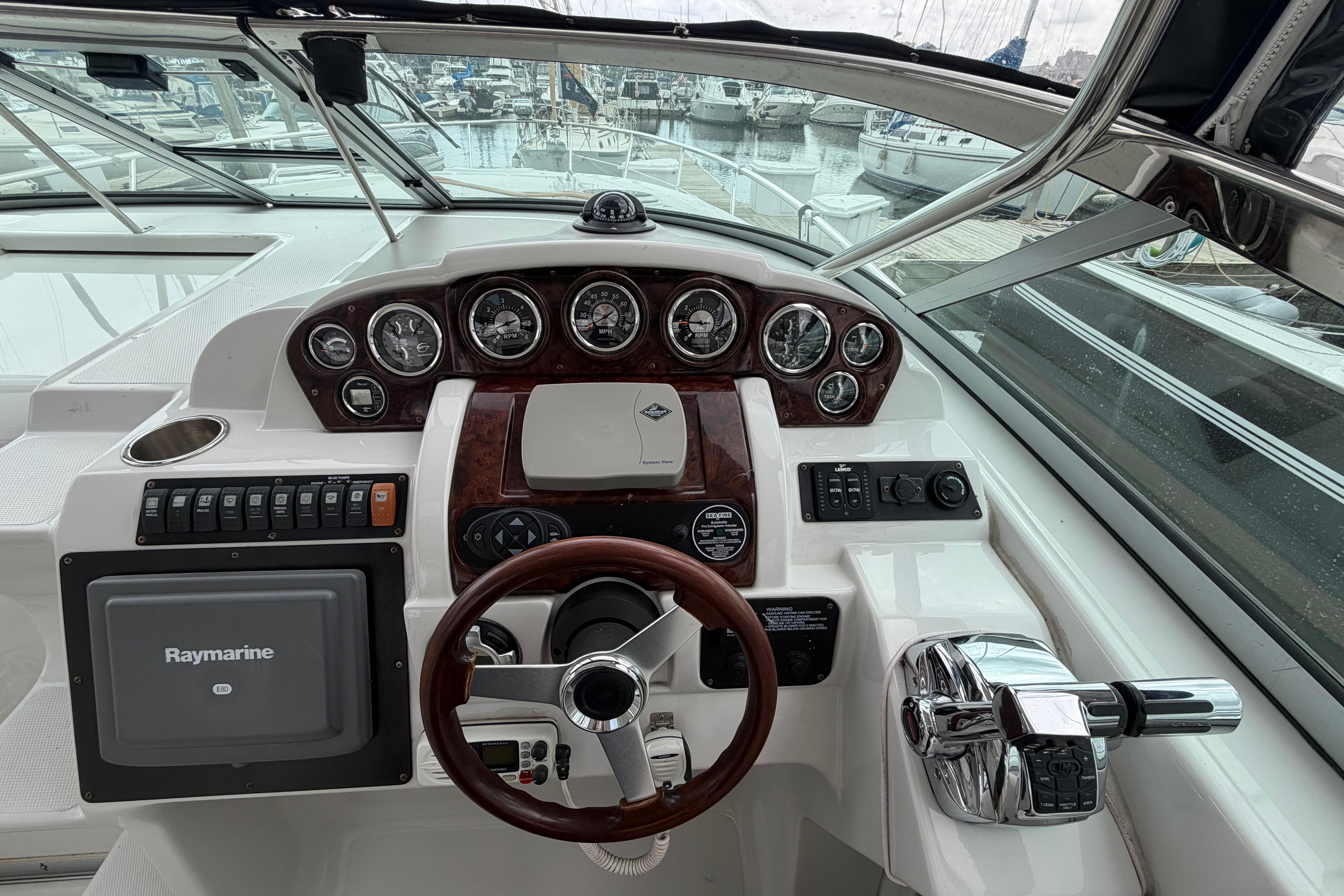 Cockpit of 2008 Crownline 340 CR boat with steering wheel and navigation instruments.