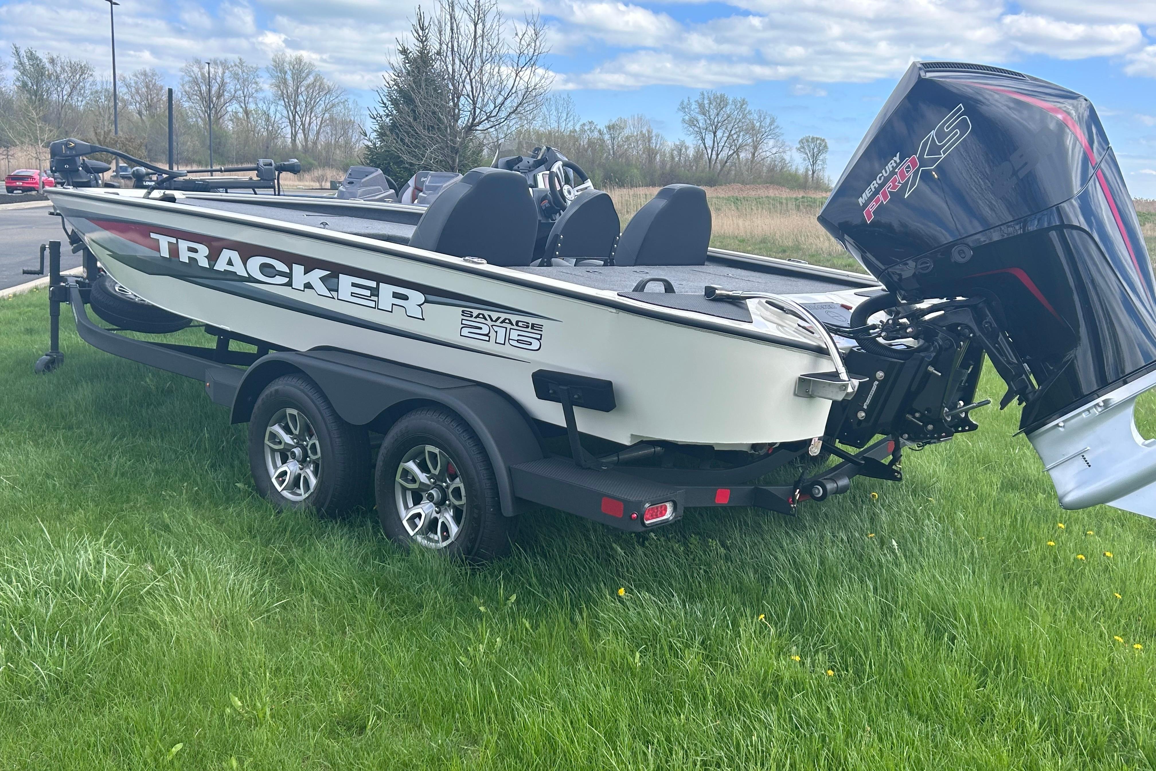 2025 Tracker Savage 215 boat on grass with Mercury Pro XS engine.