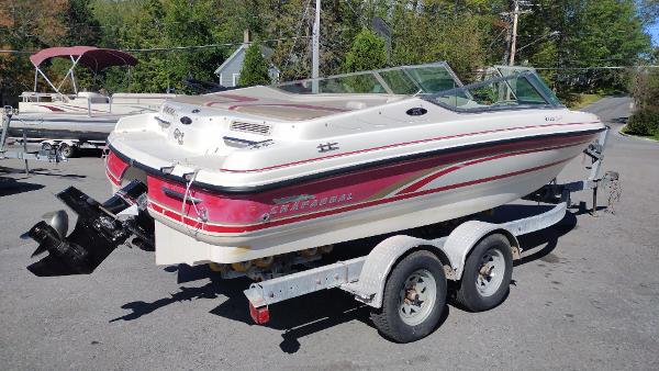 1999 Chaparral 2130 SS boat on trailer, parked outdoors.