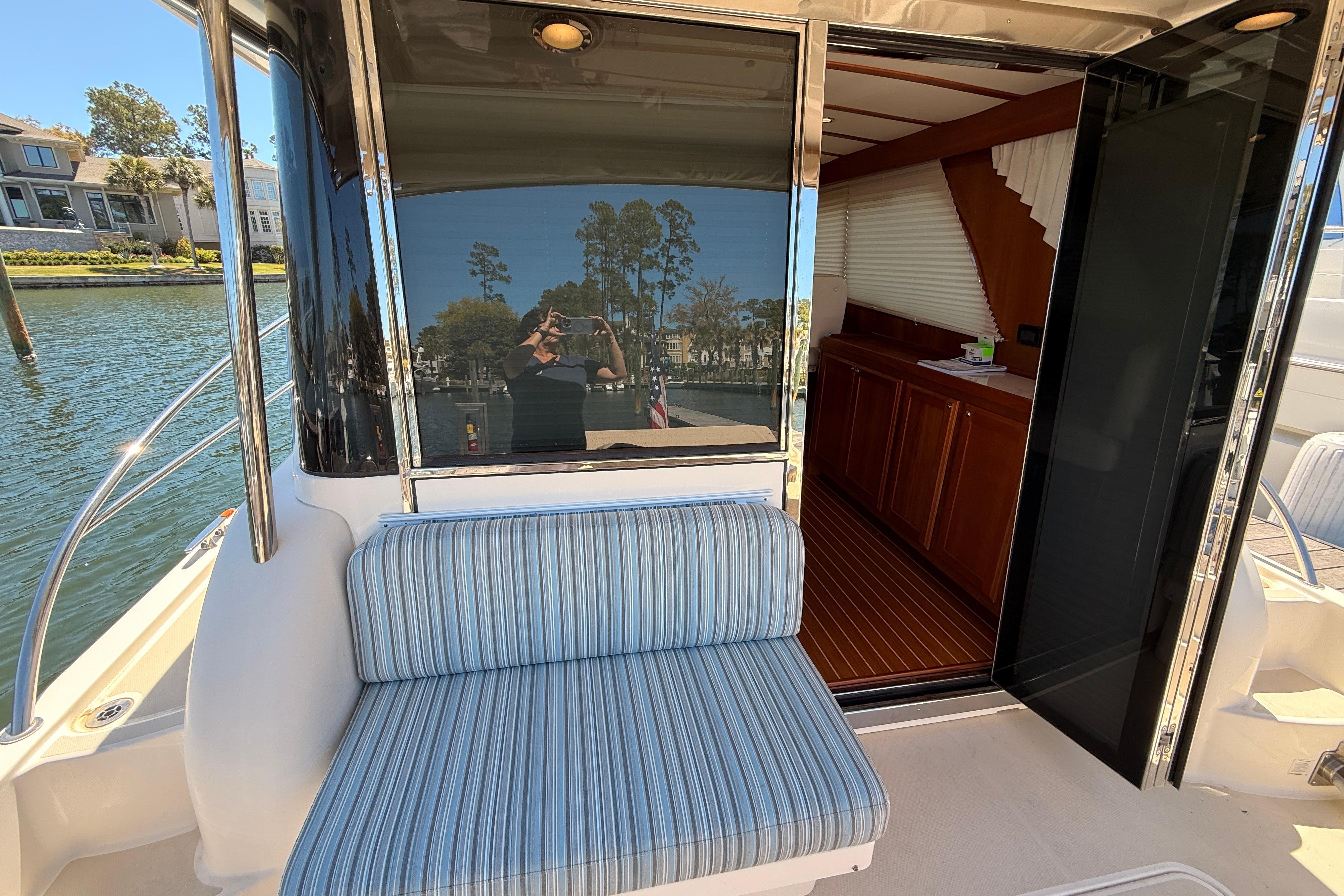 2022 Sabre 38 Salon Express yacht with striped seating and open cabin door.