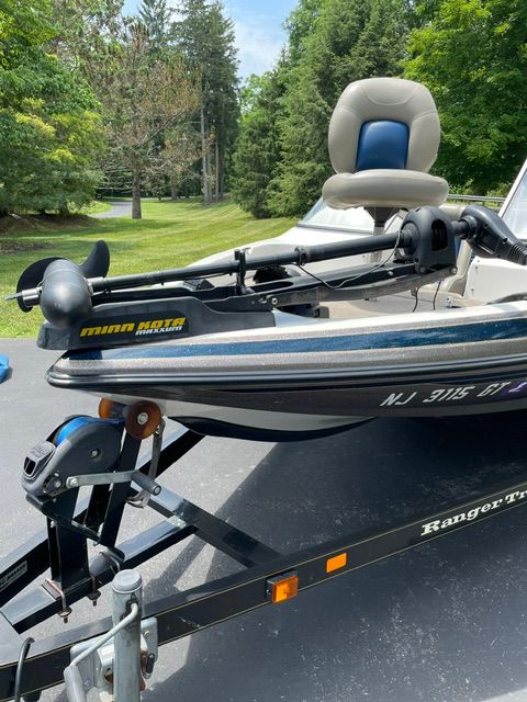 A 2004 Ranger 190 Reata boat on a trailer, surrounded by trees.