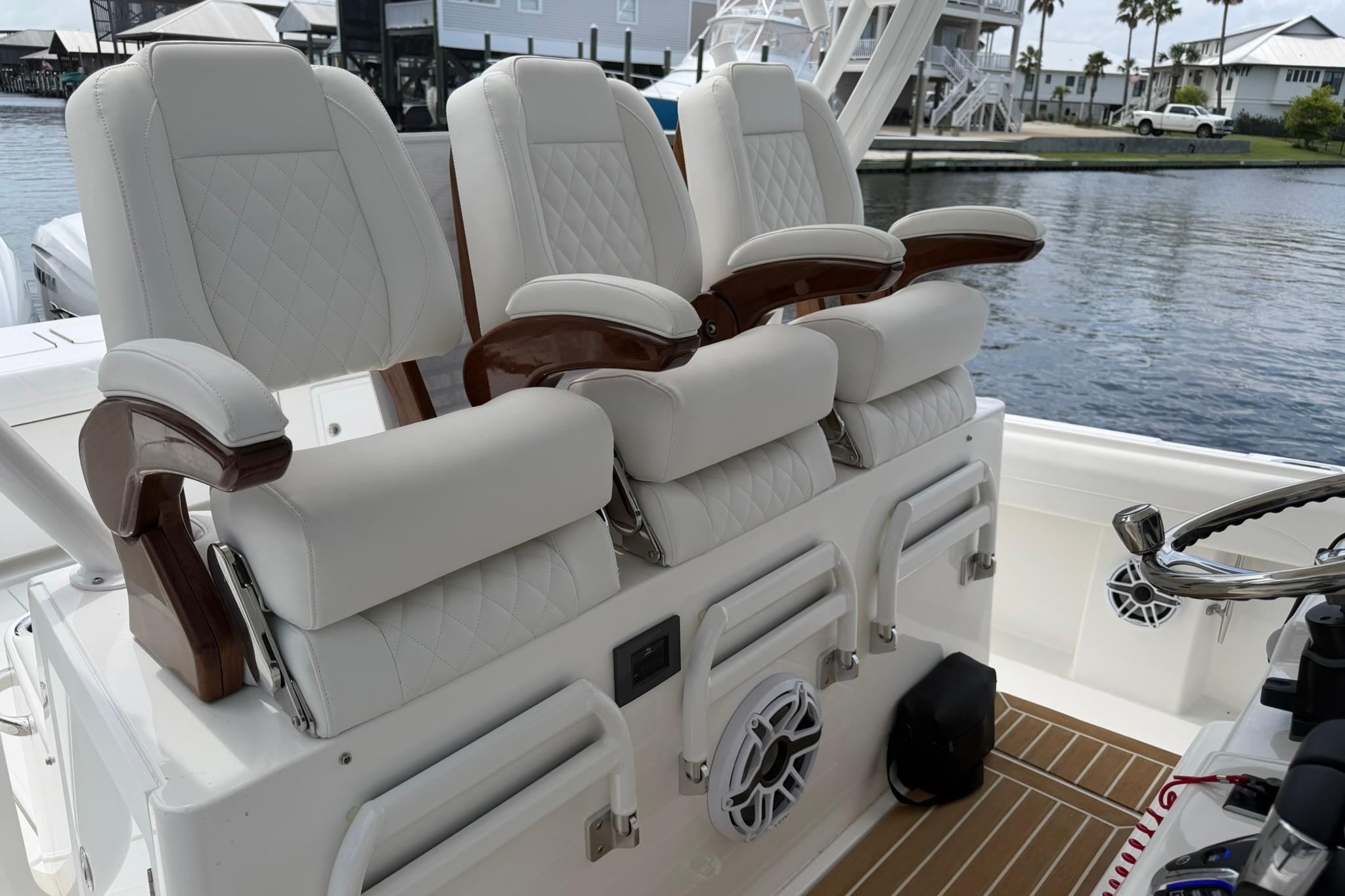 Luxury seating on 2026 Regulator 37 boat, featuring elegant white upholstery and wooden accents.