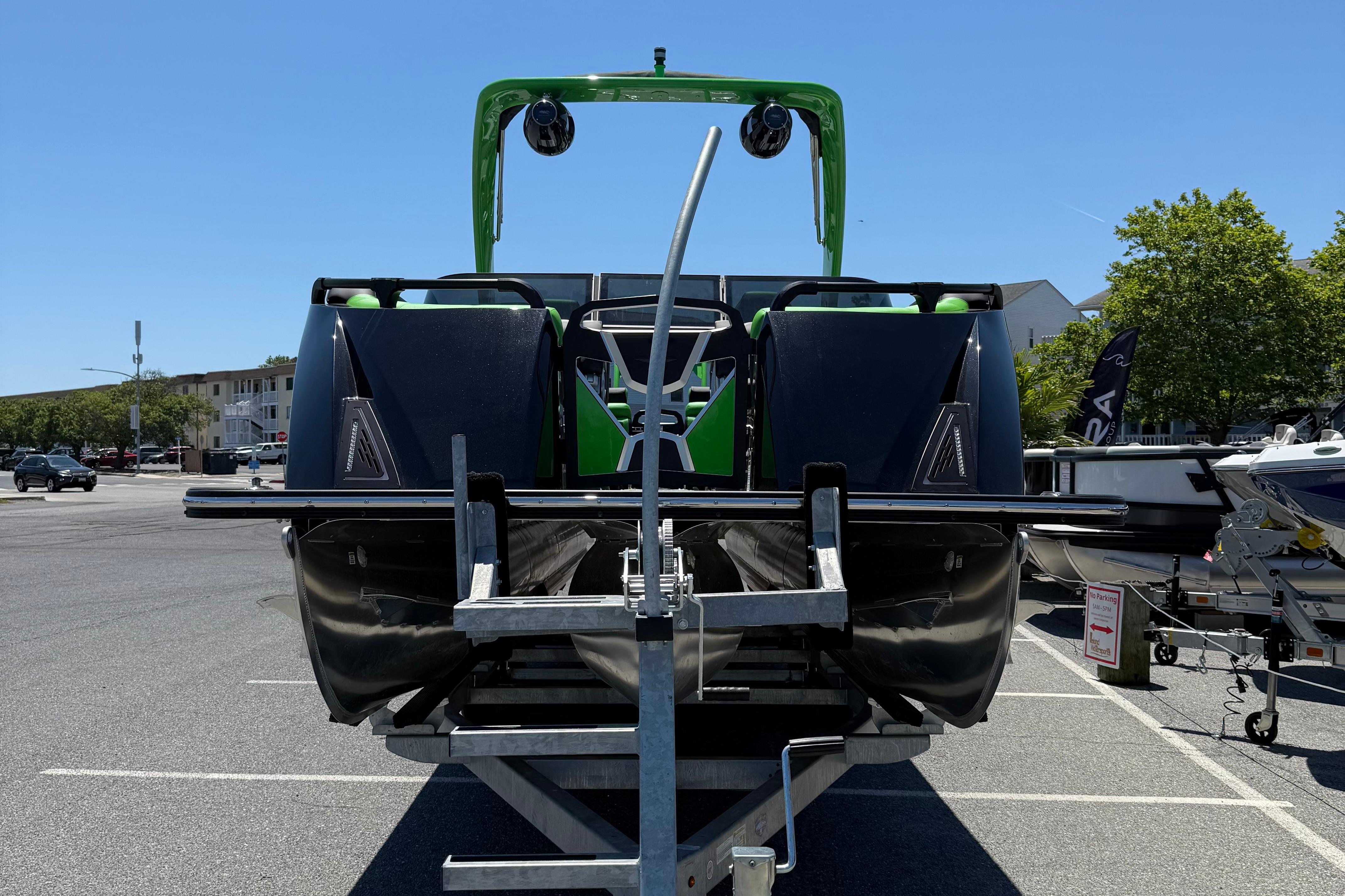 2026 Berkshire Sport SLX9 DC boat on trailer in parking lot, rear view.