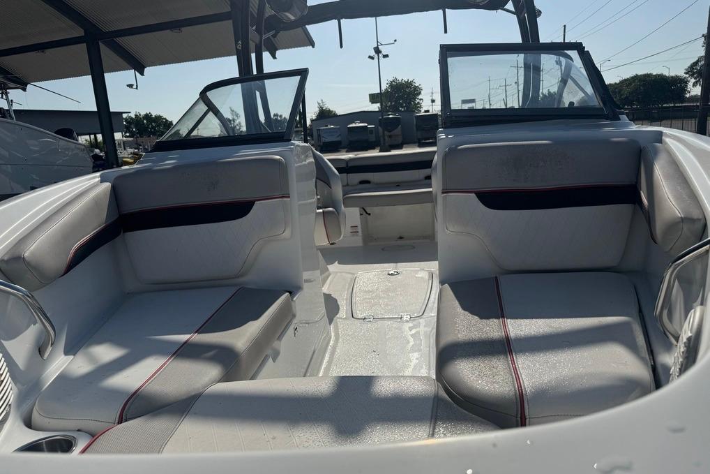 2018 Tahoe 700 TF boat interior with seating and open deck under a canopy.