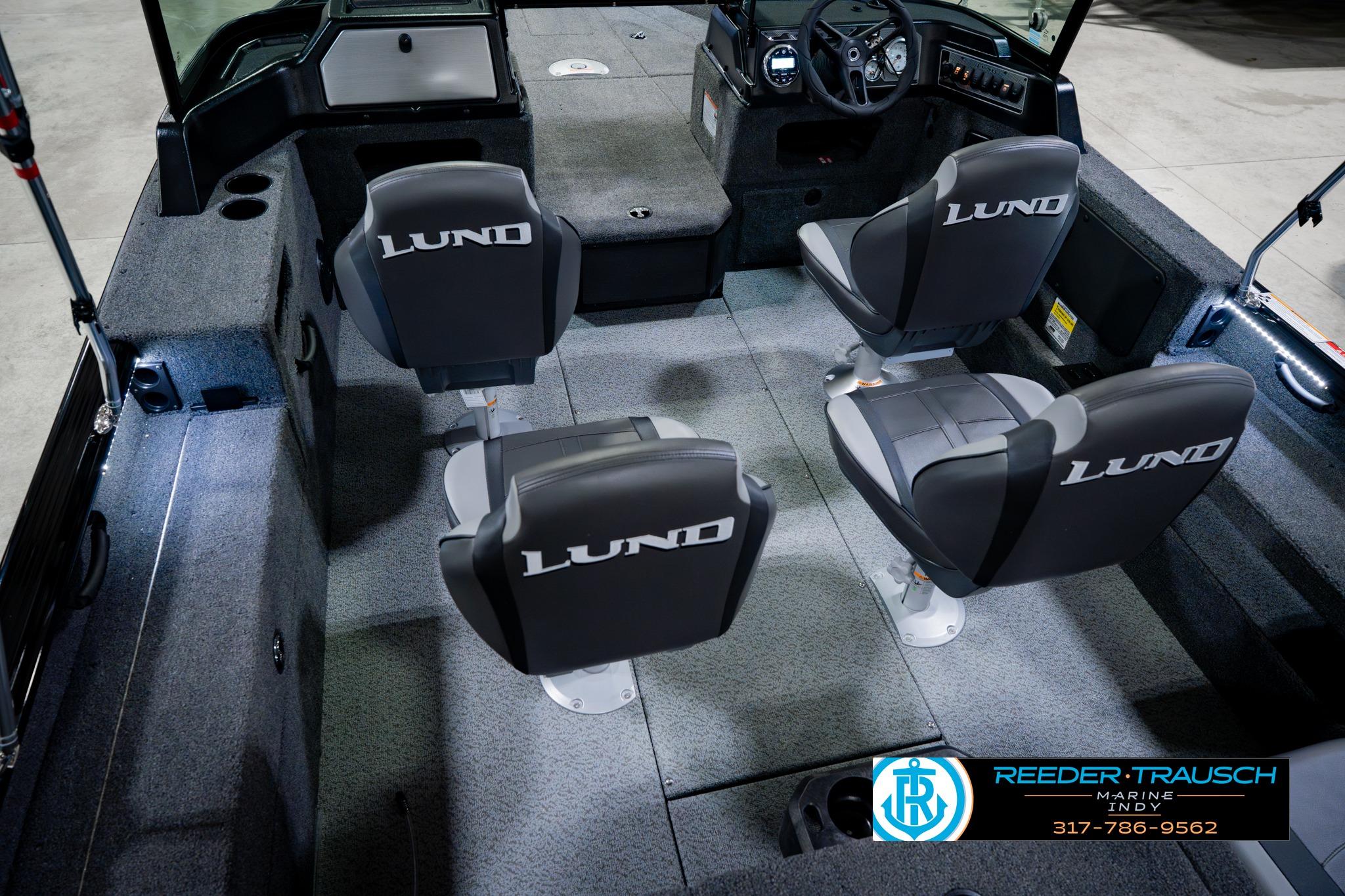 Interior of 2026 Lund 1875 Impact XS boat with four swivel seats and modern dashboard.