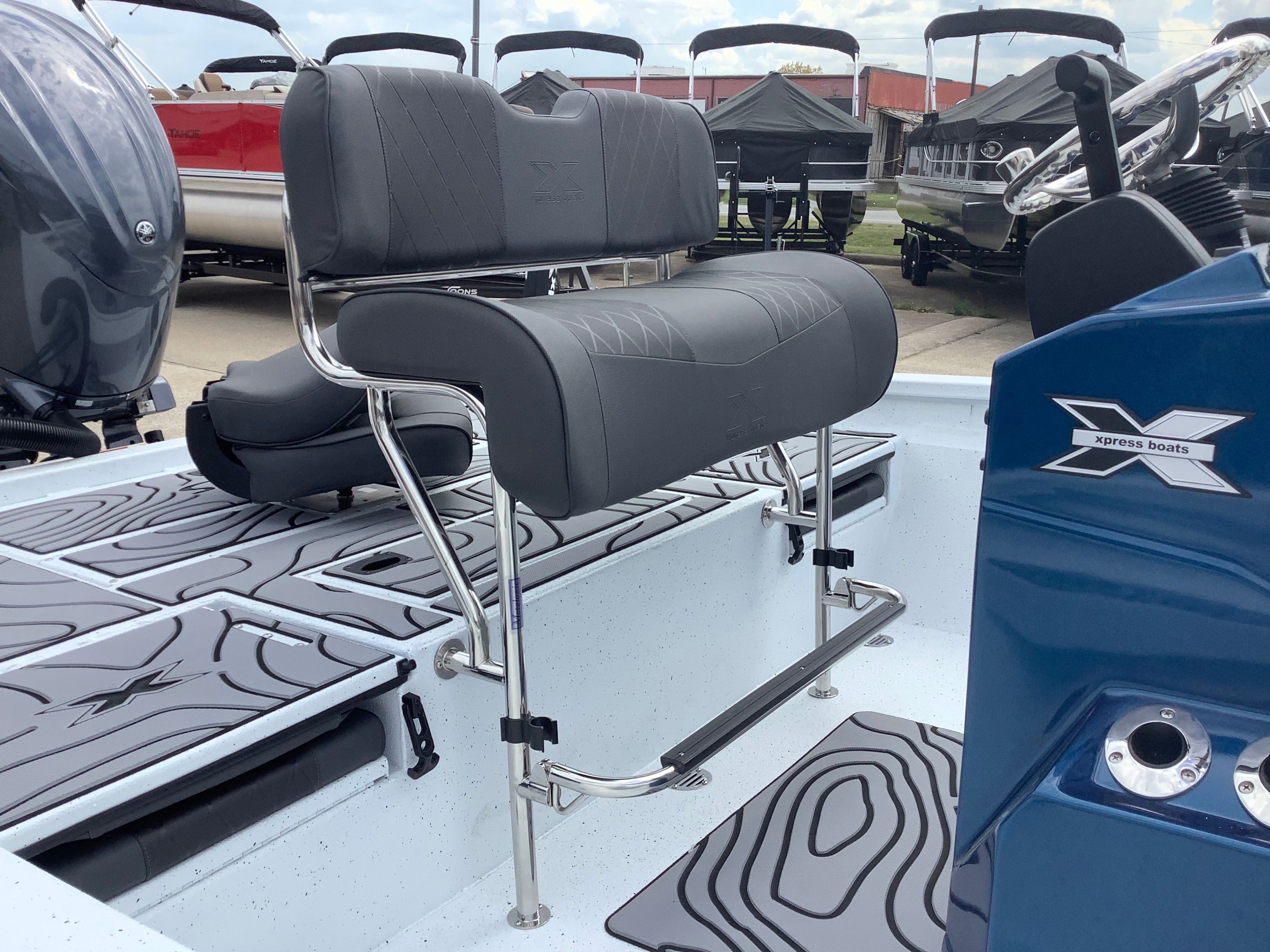 2026 Xpress H22B Bay boat with gray seats and blue helm console.