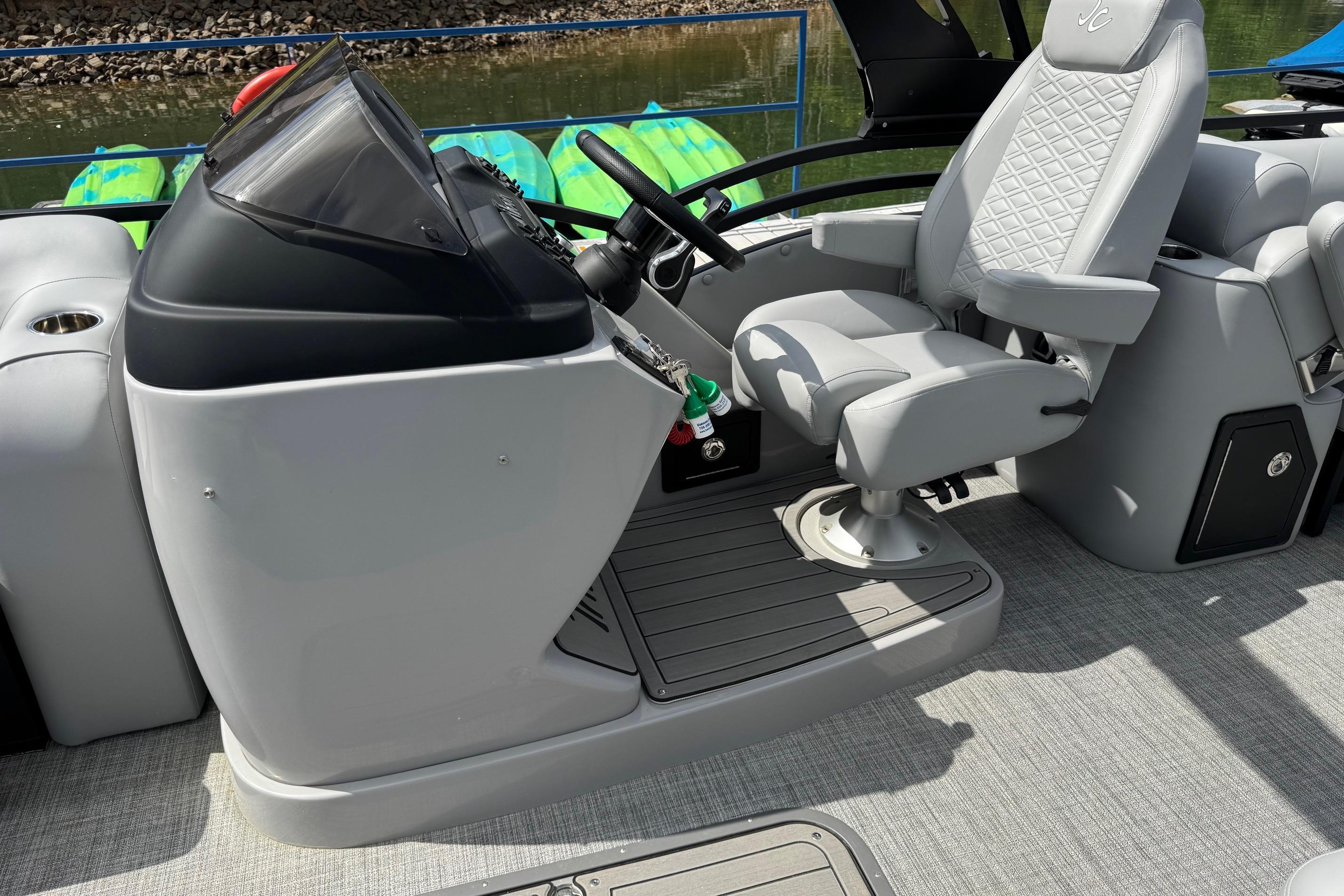 Helm of 2026 JC Neptoon Sport 23TT DSL boat with luxurious seating and controls.