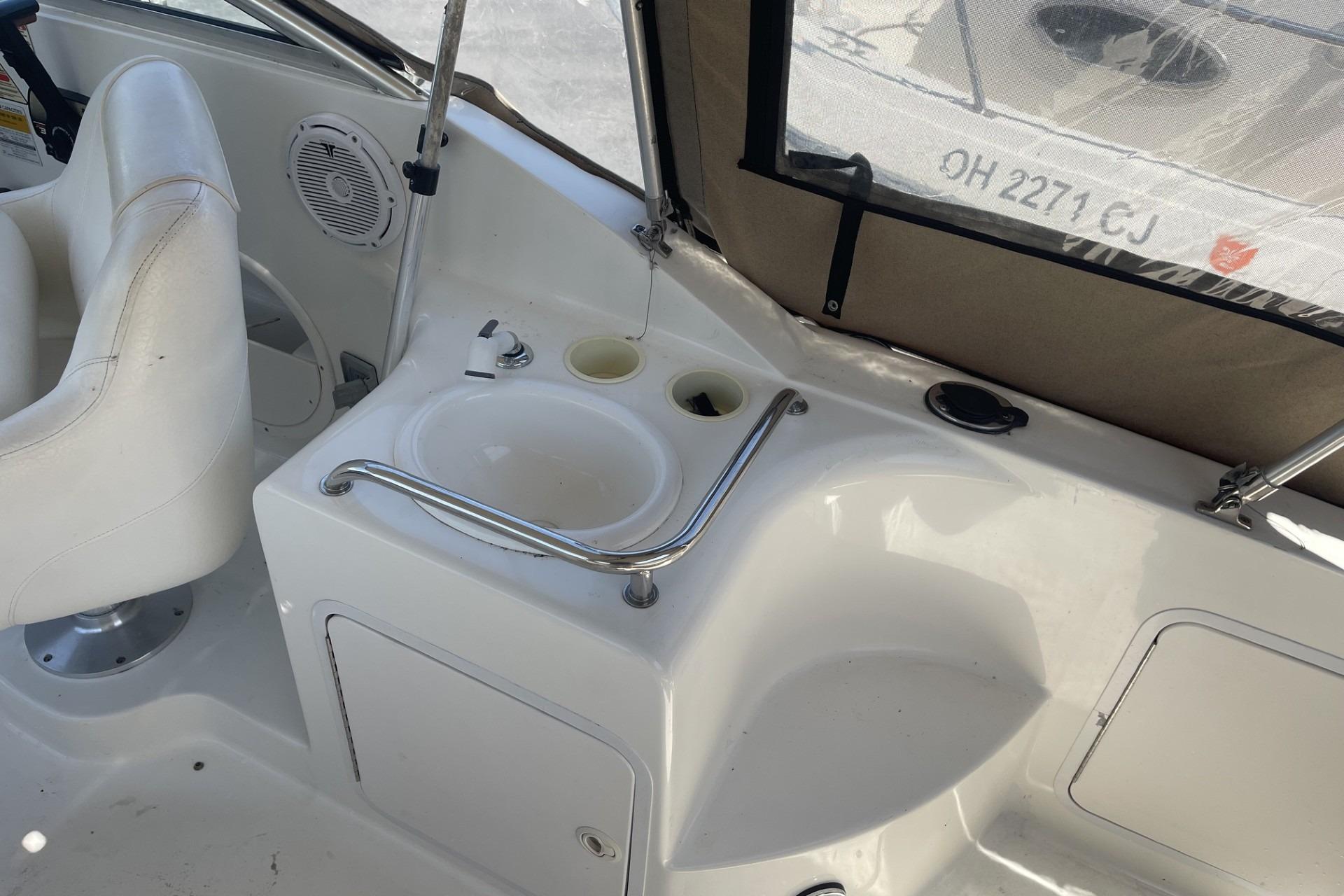 Interior of a 2000 Sea Ray Sundancer 260 boat, featuring a sink and seating area.