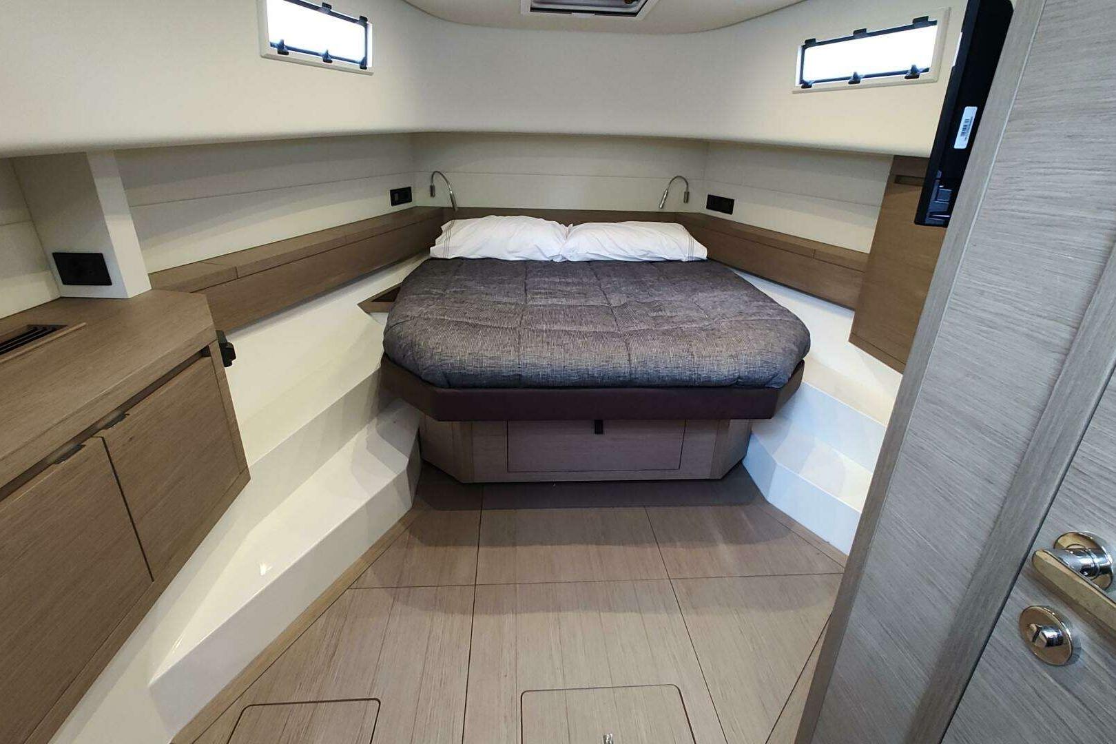 Luxurious cabin interior of 2023 Pardo Yachts P43 with modern design and cozy bed.